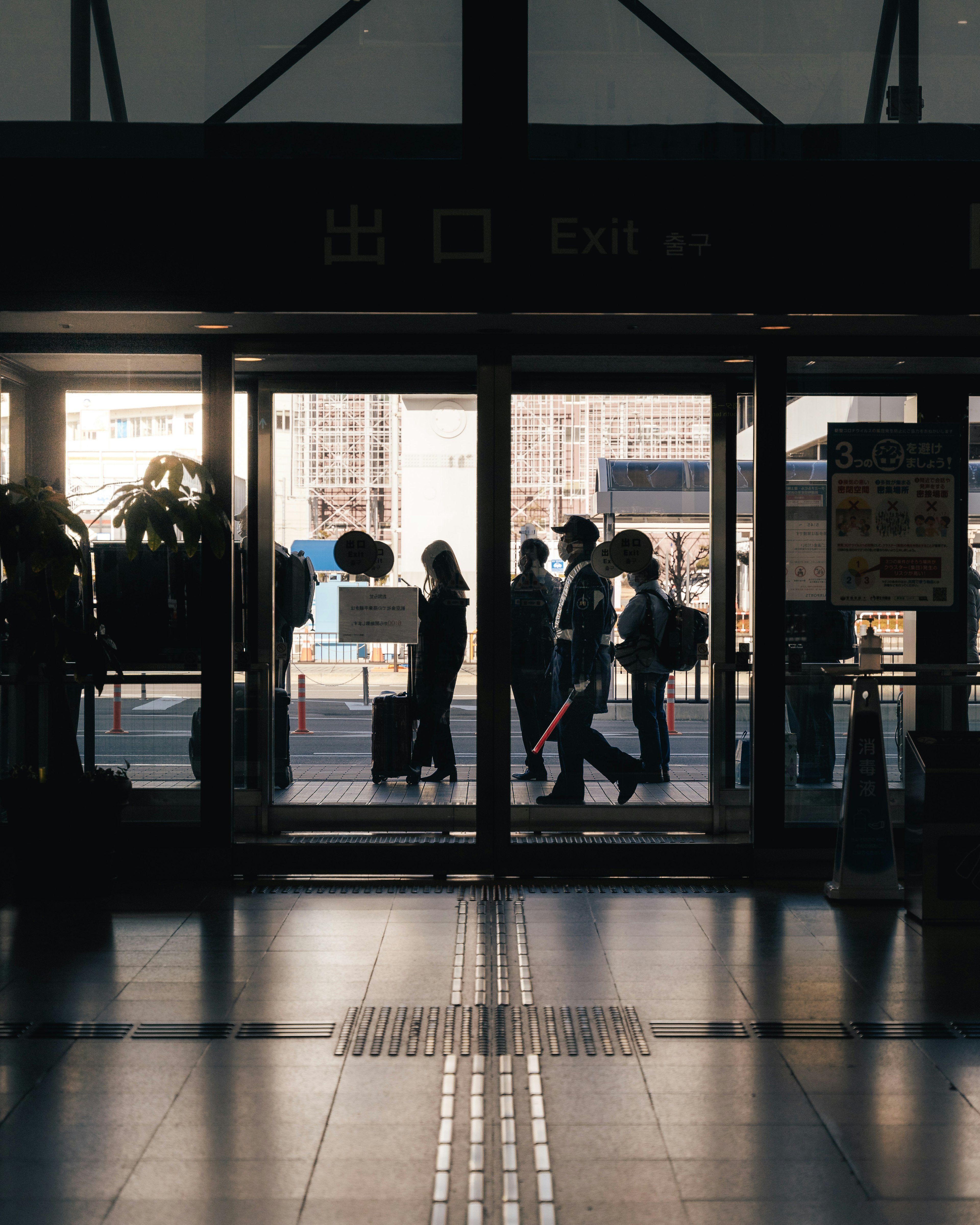 People walking through a train station entrance