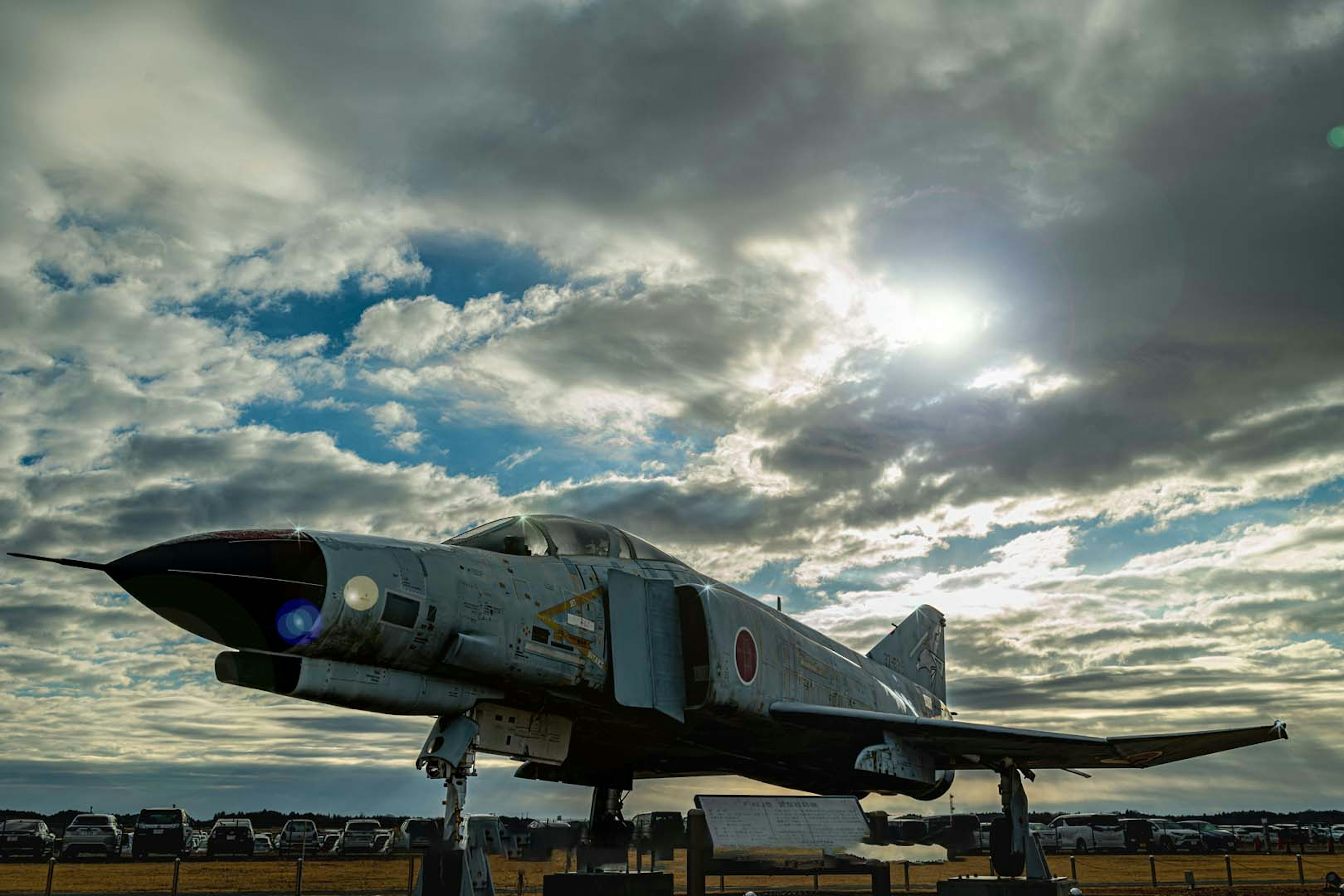 Japanese aircraft displayed outdoors under a cloudy sky