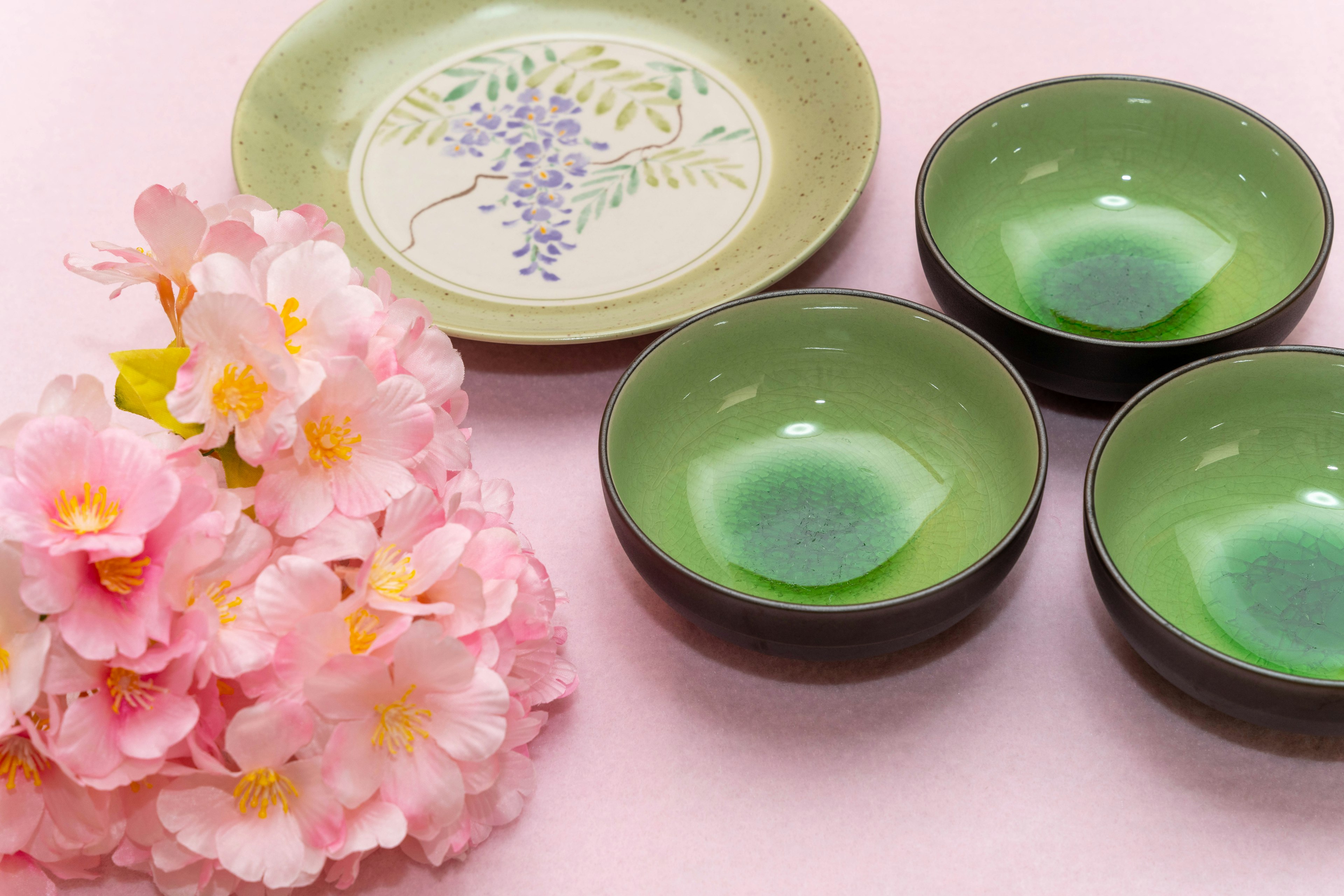 Set of green bowls and floral arrangement featuring Japanese tableware