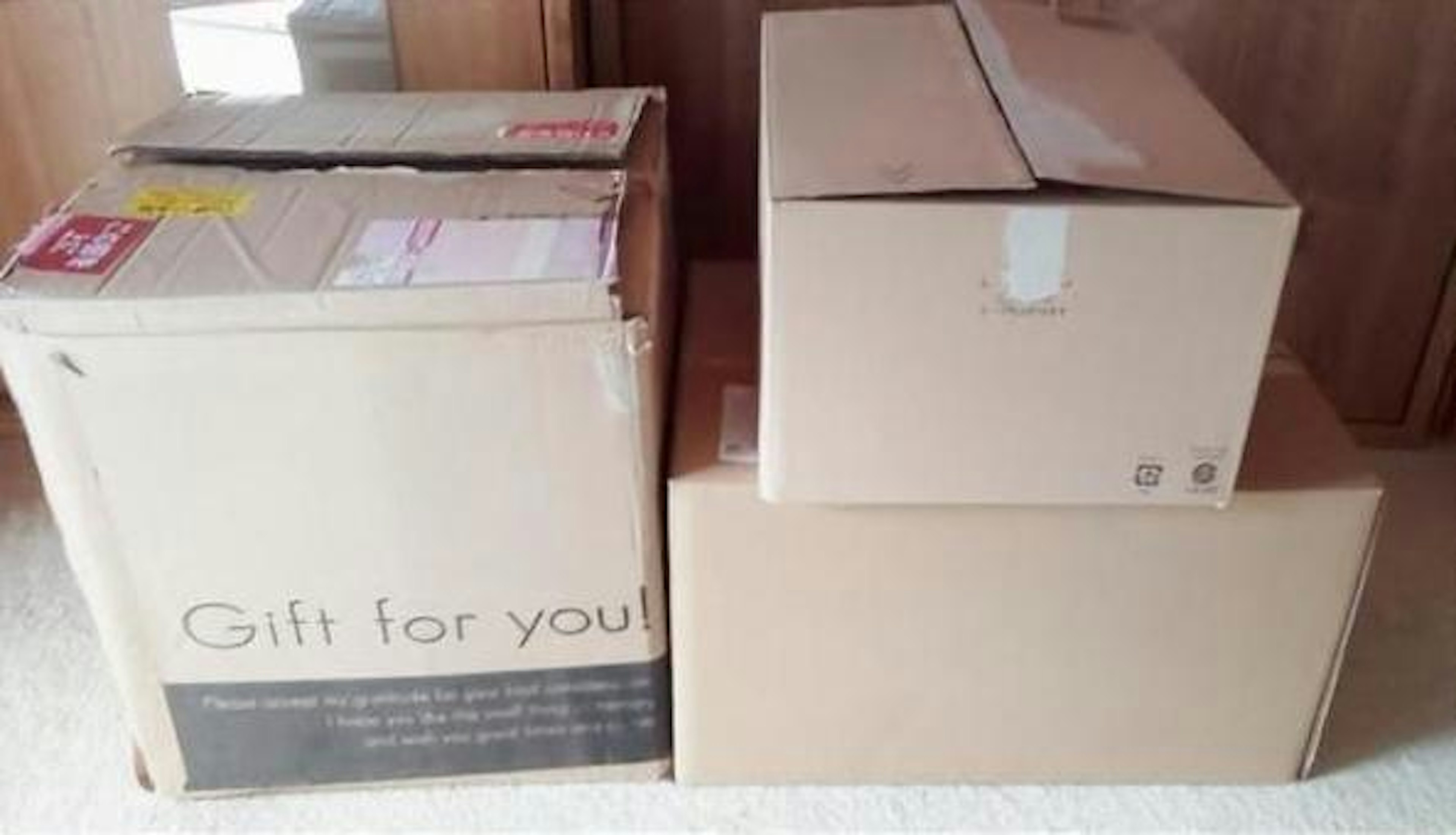 Several cardboard boxes stacked with one labeled Gift for you