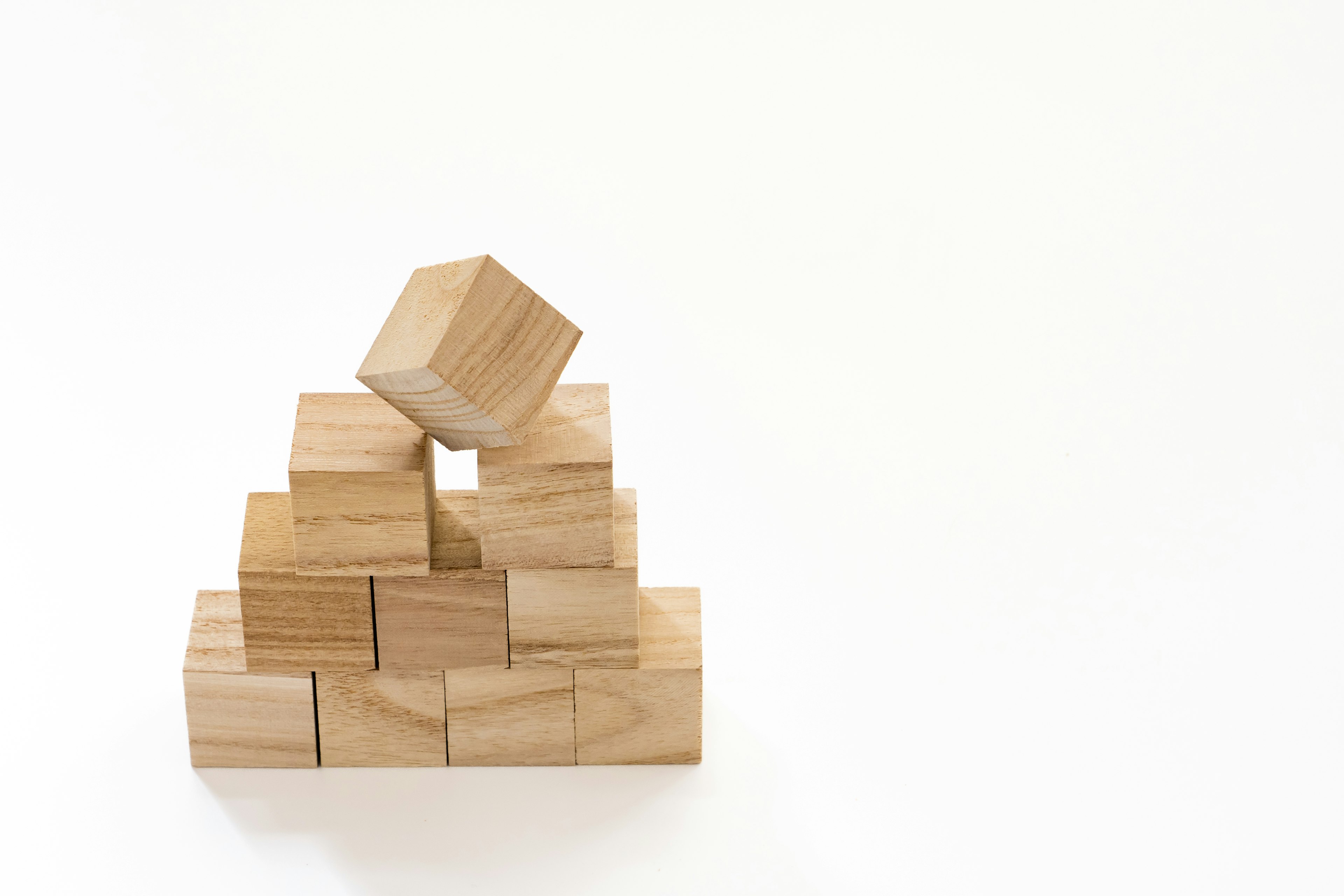 Pyramid of wooden blocks with one block on top