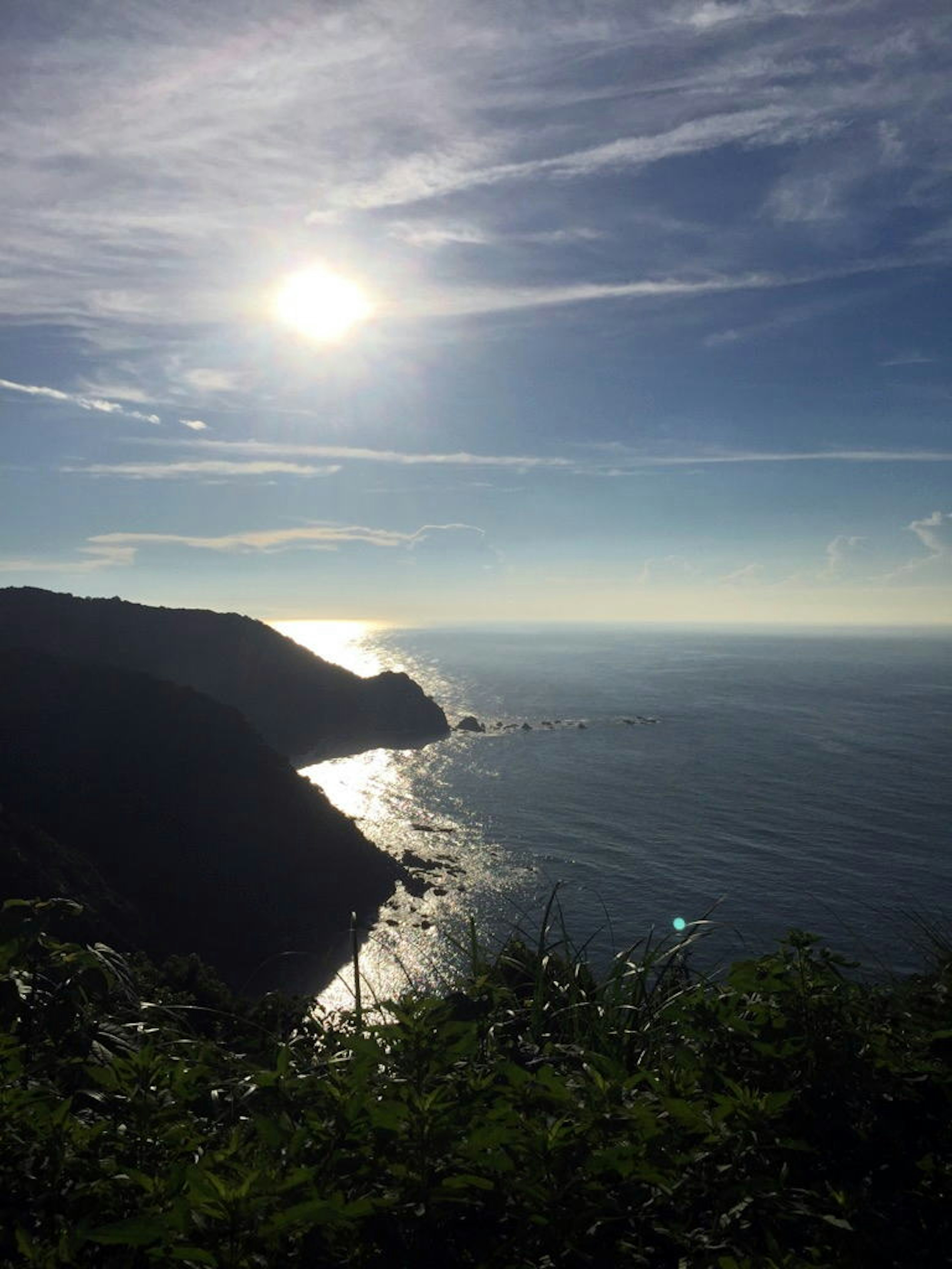 Ligne de côte avec la lumière du soleil se reflétant sur l'océan