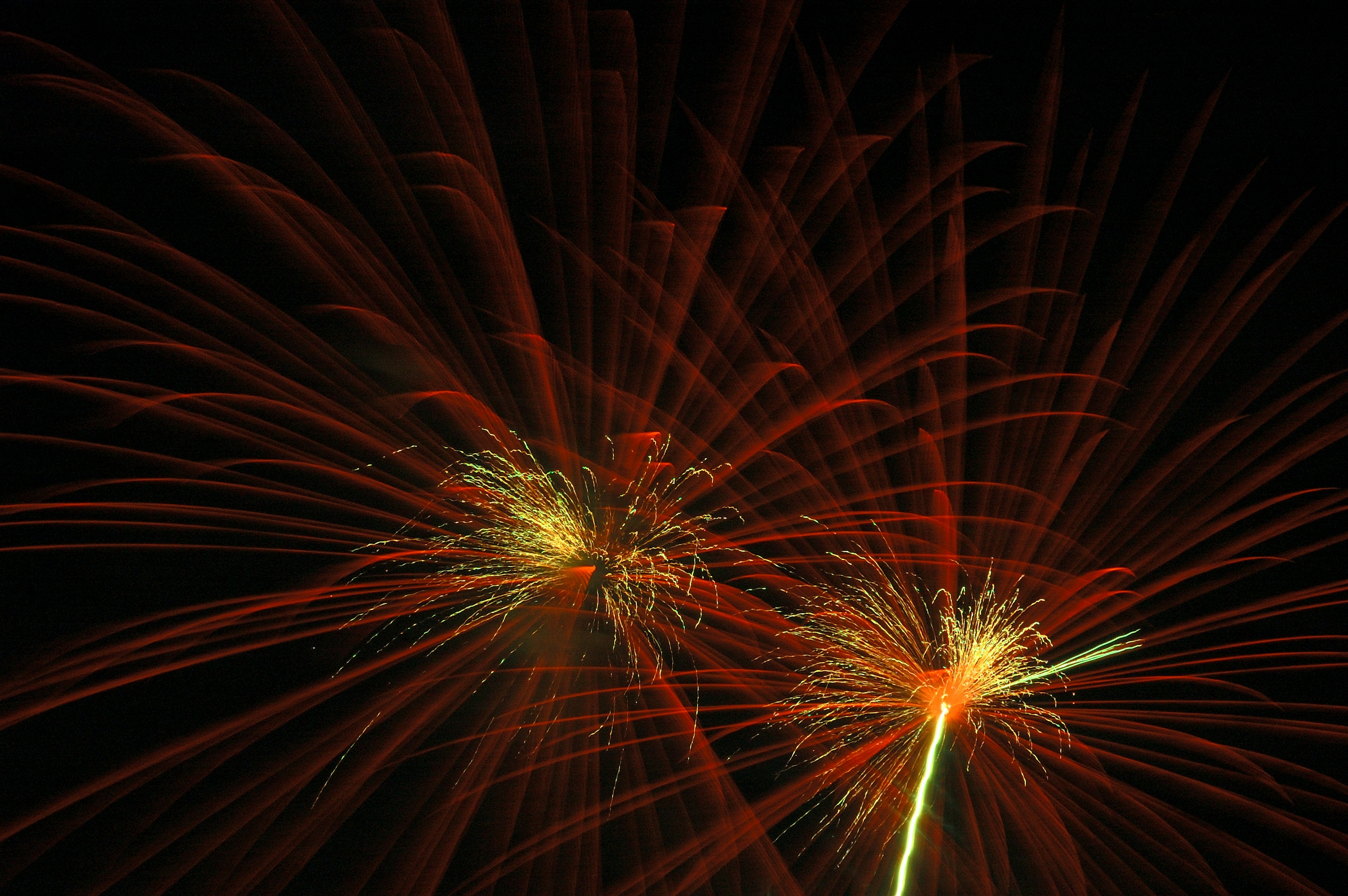 Exploding red fireworks in the night sky