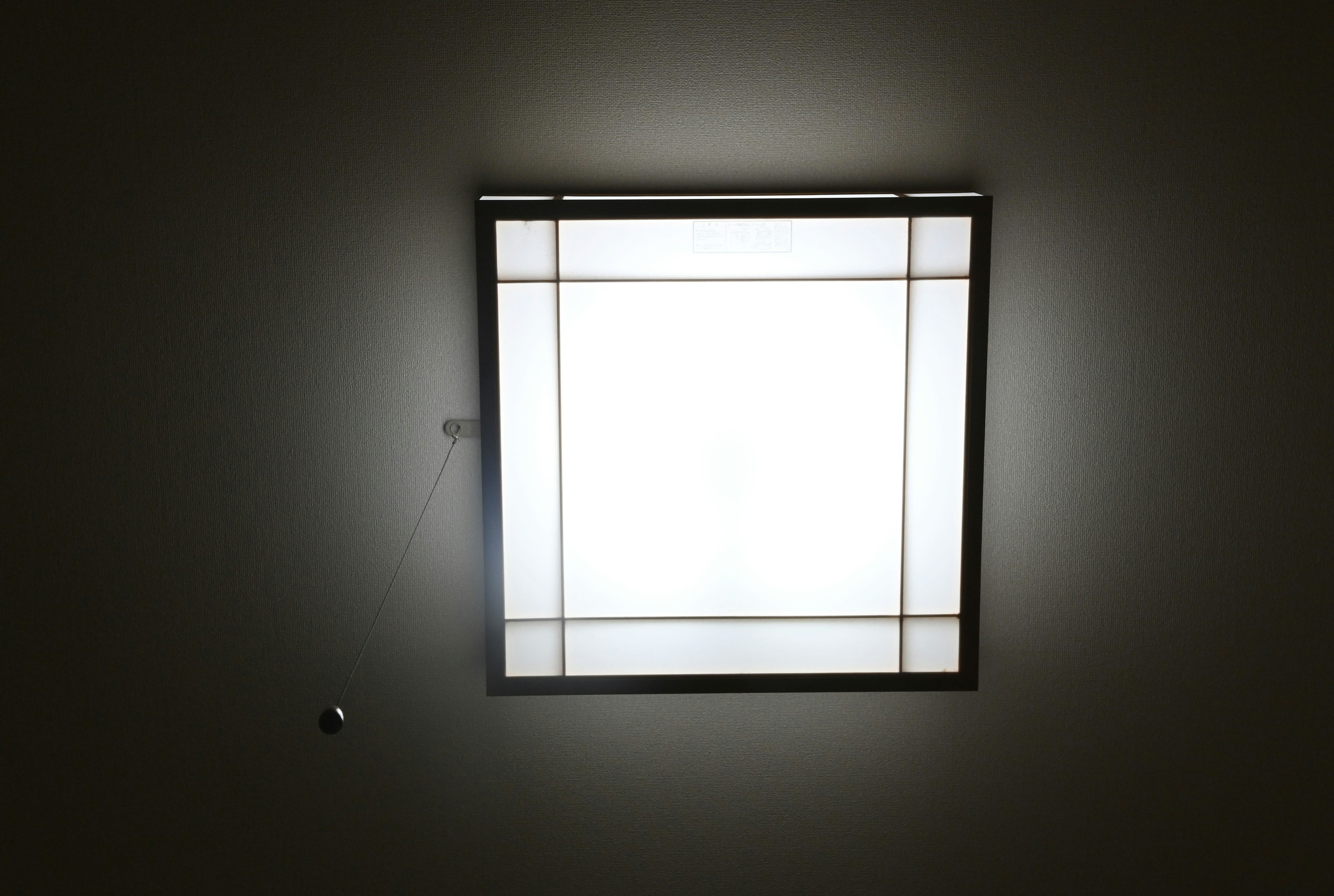 Square ceiling light fixture emitting bright light simple design