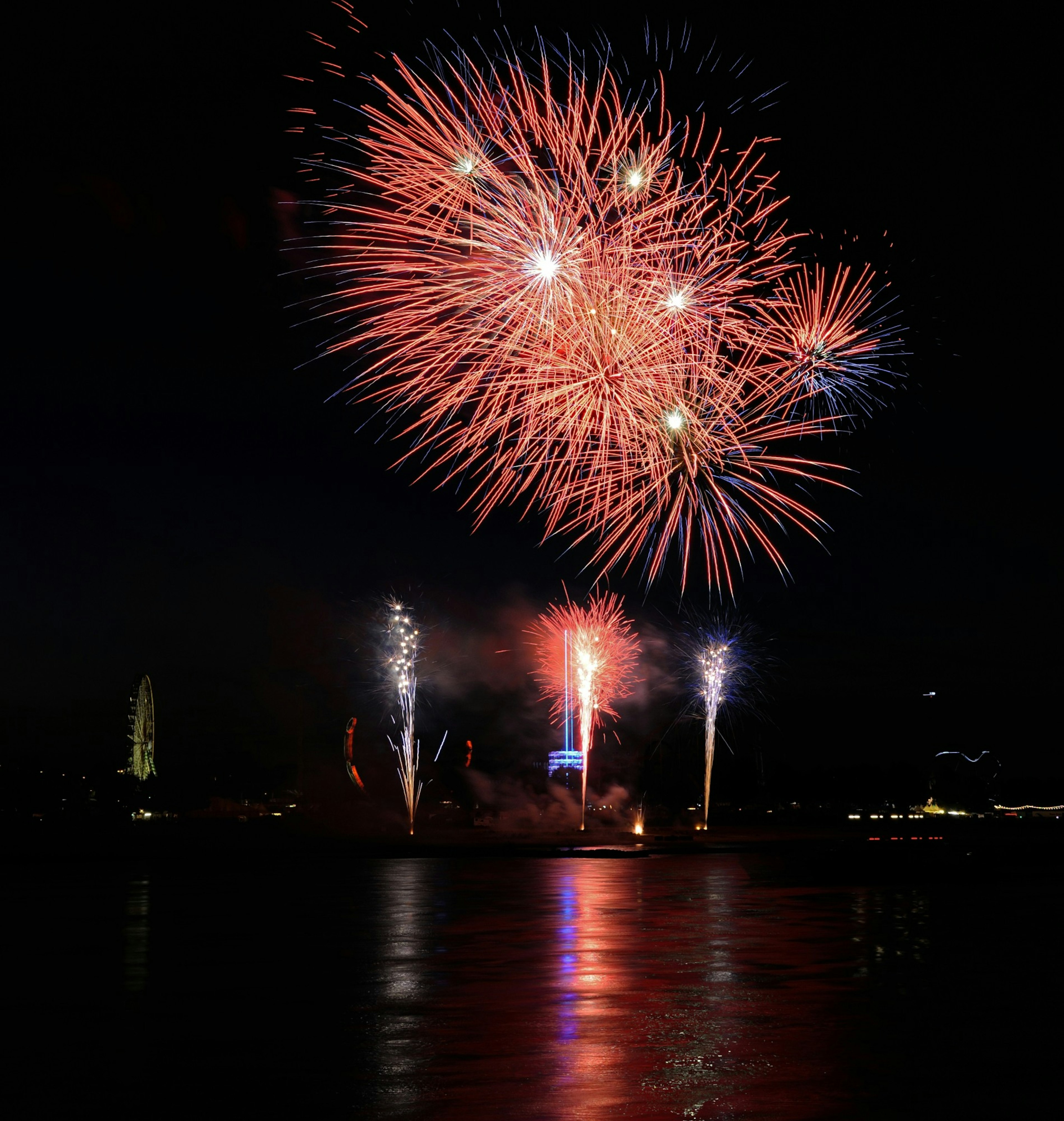 Beautiful fireworks display in the night sky vibrant red and blue colors shining