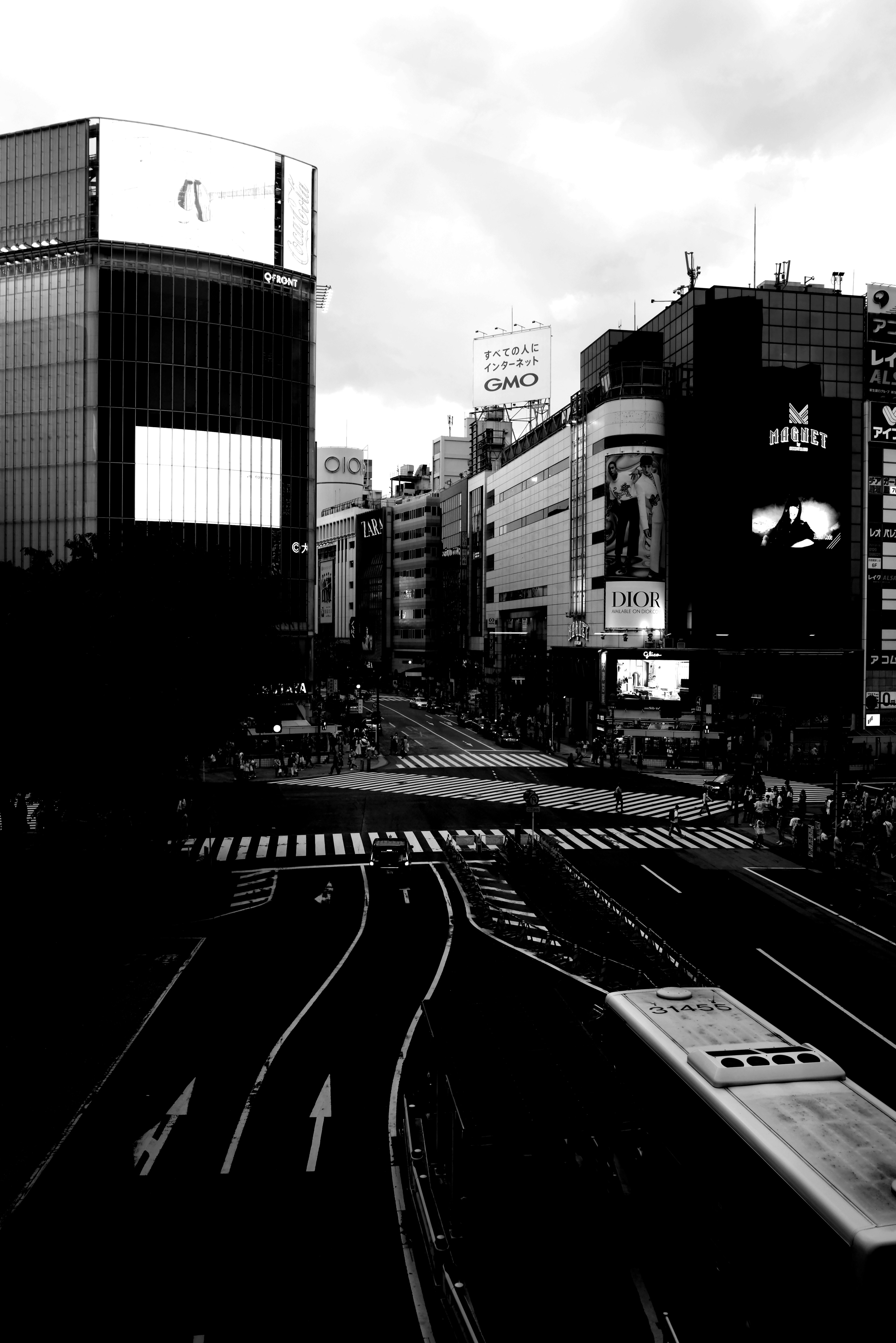 Black and white urban scene featuring an intersection and buildings