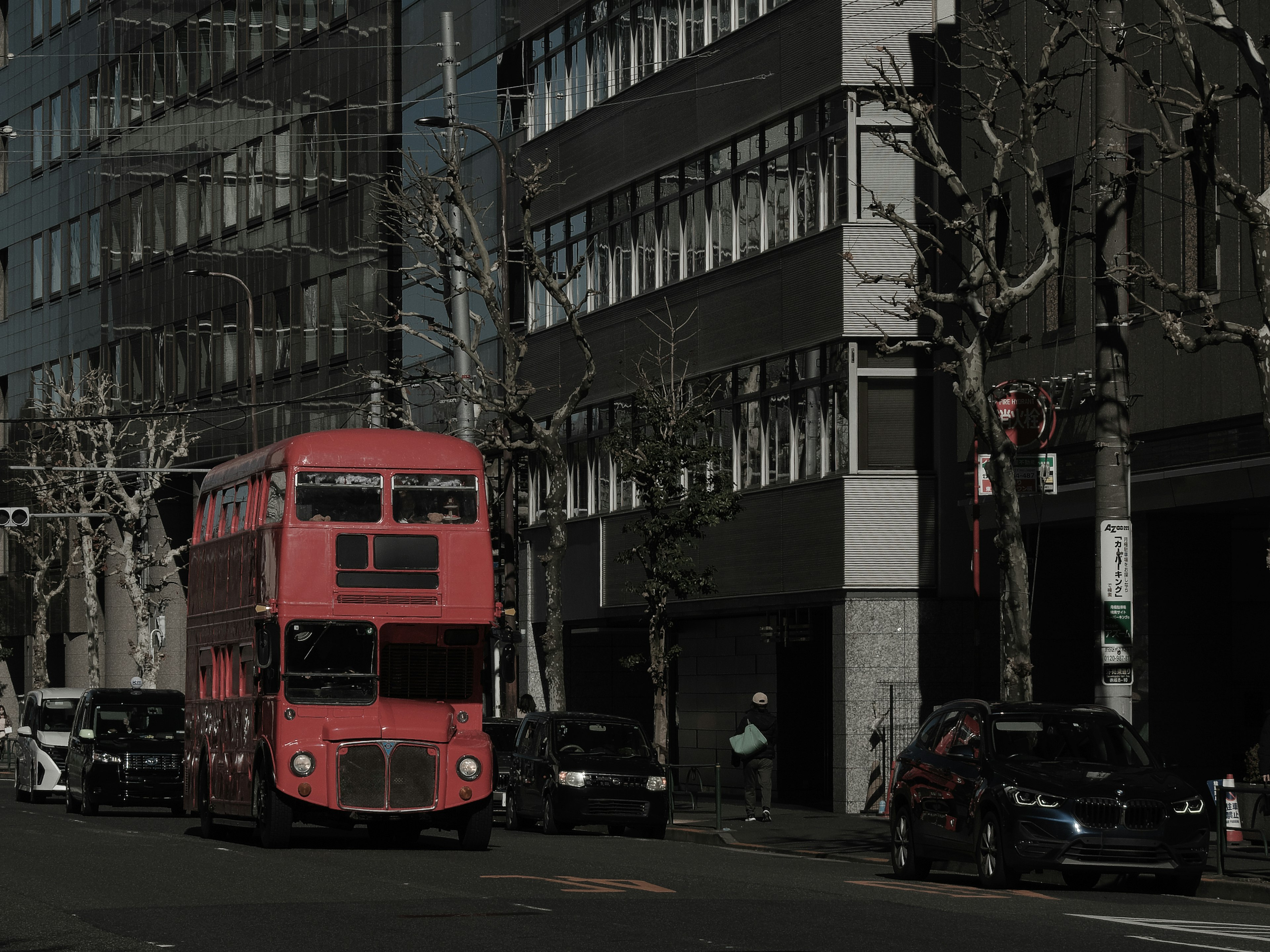 Red double-decker bus driving through Tokyo