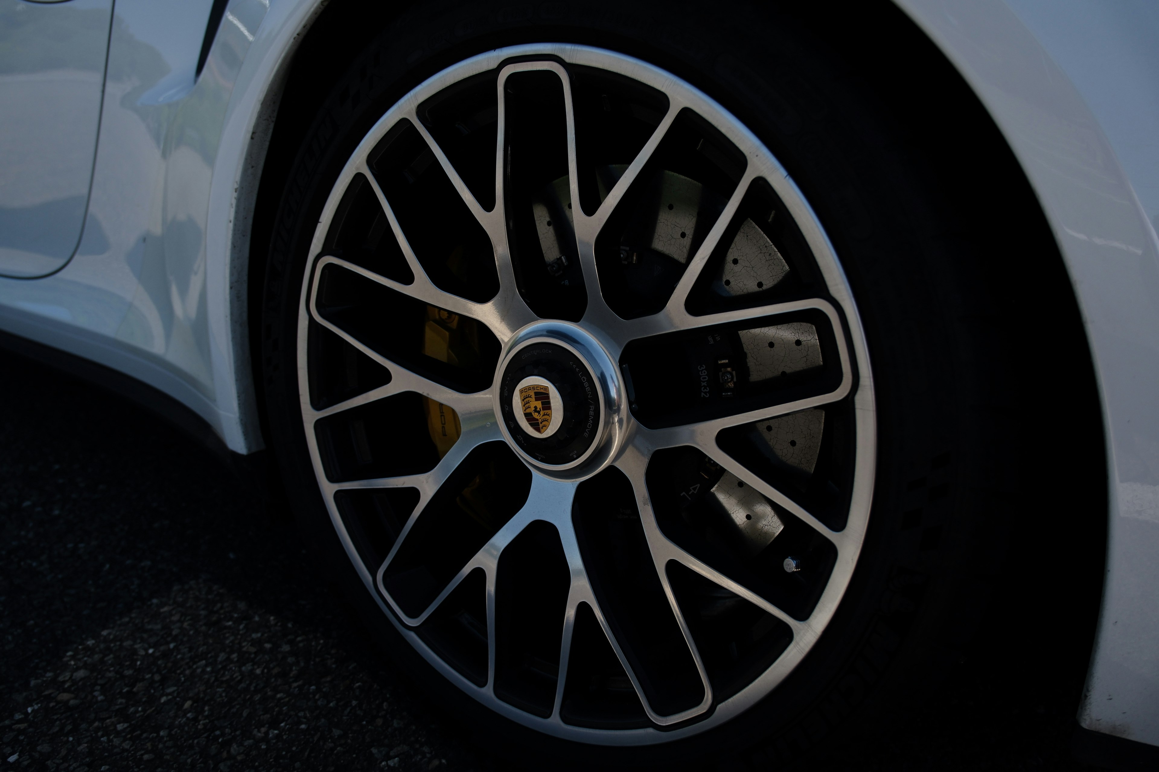 Close-up of a Porsche wheel showcasing glossy silver spokes