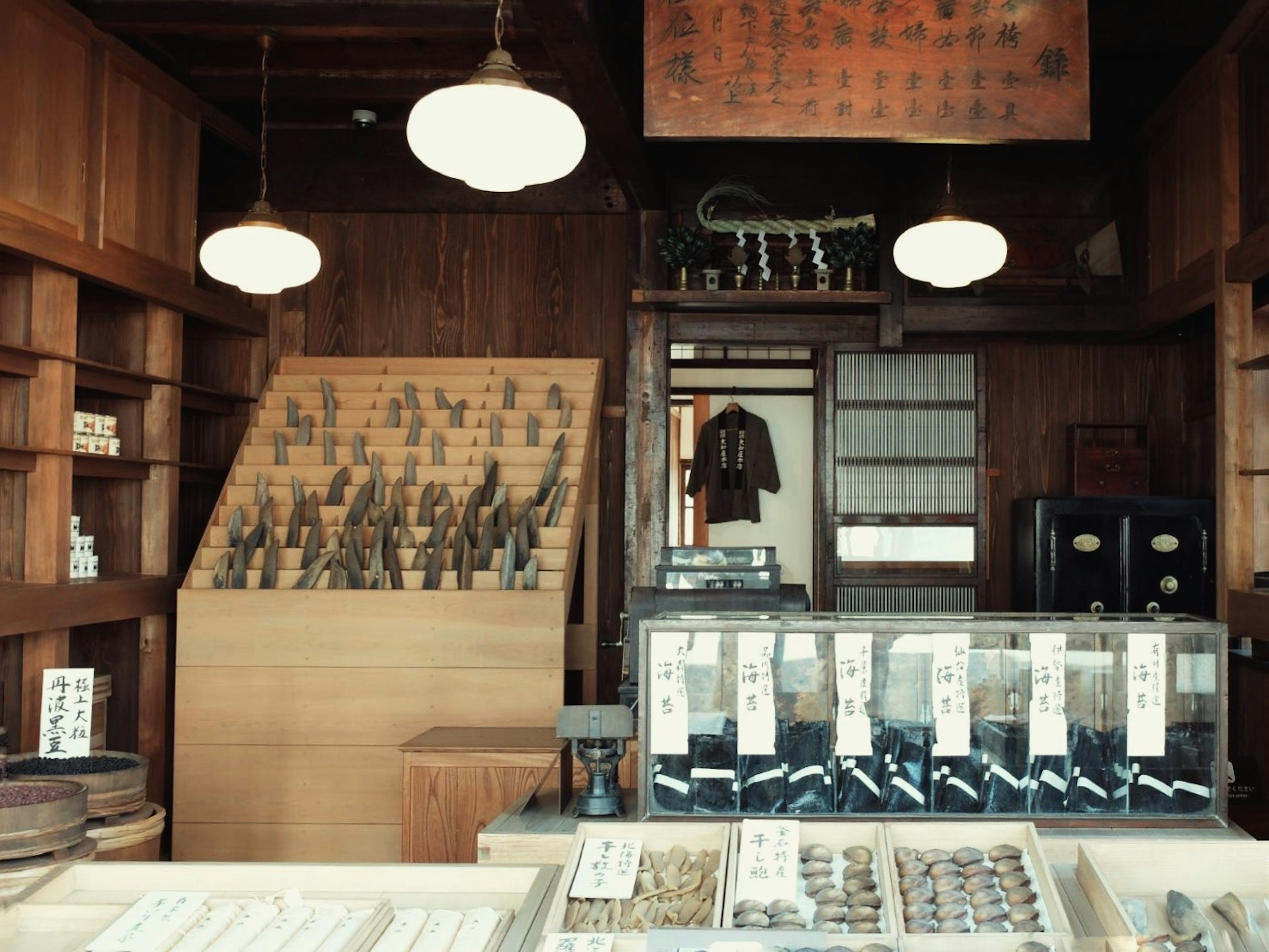 Traditional Japanese shop interior with wooden shelves and lighting showcasing various products