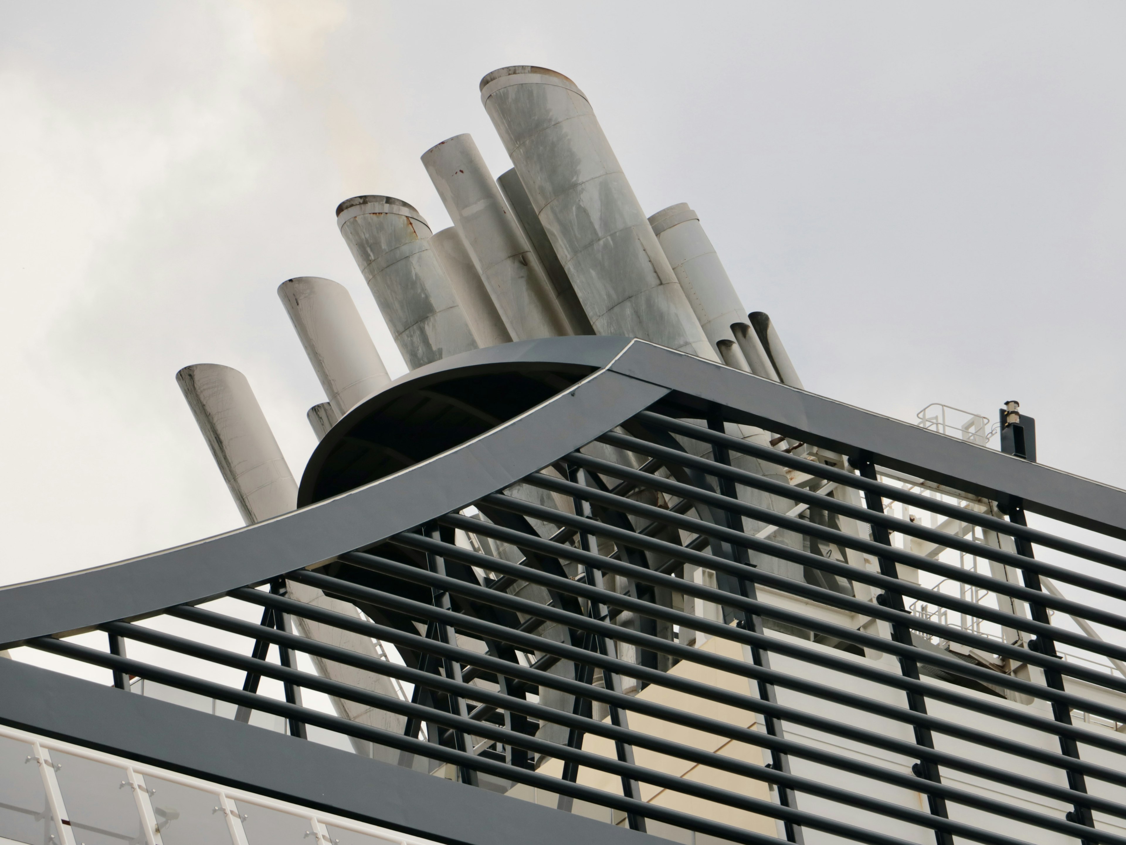 Metal pipes on a building rooftop with a lattice design