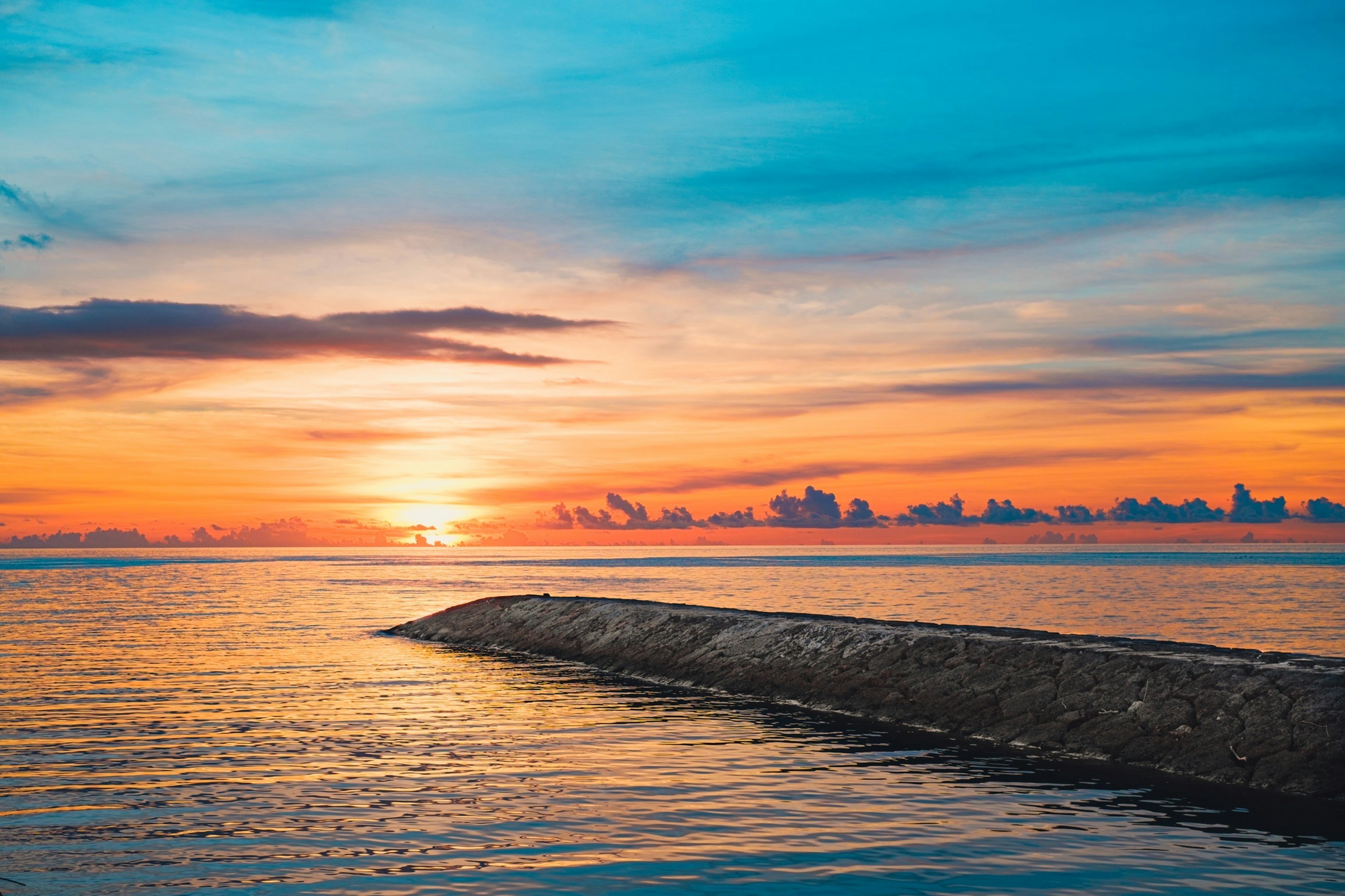 Beautiful sunset over the ocean with calm water surface