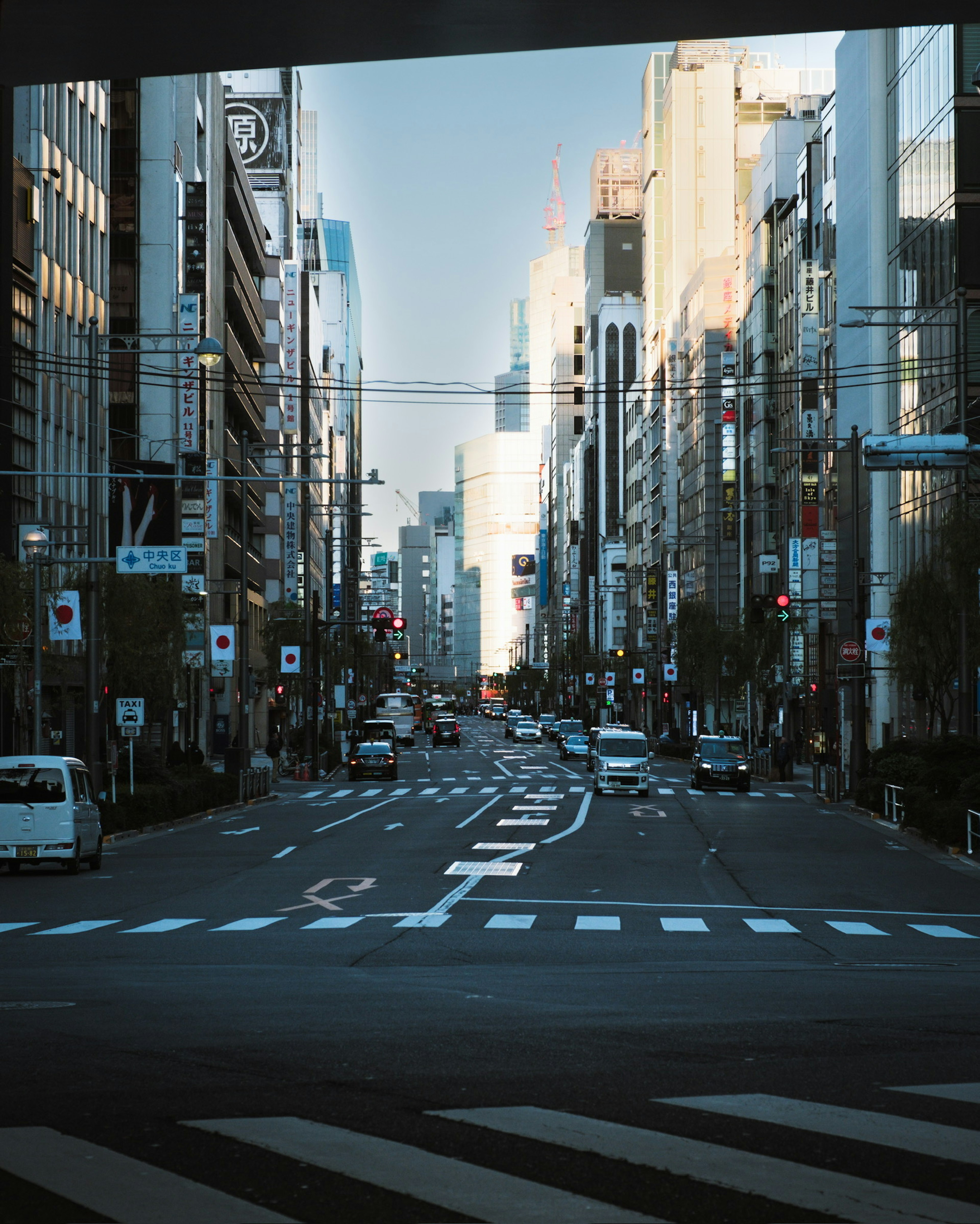 View of a bustling street in Tokyo with tall buildings and vehicles