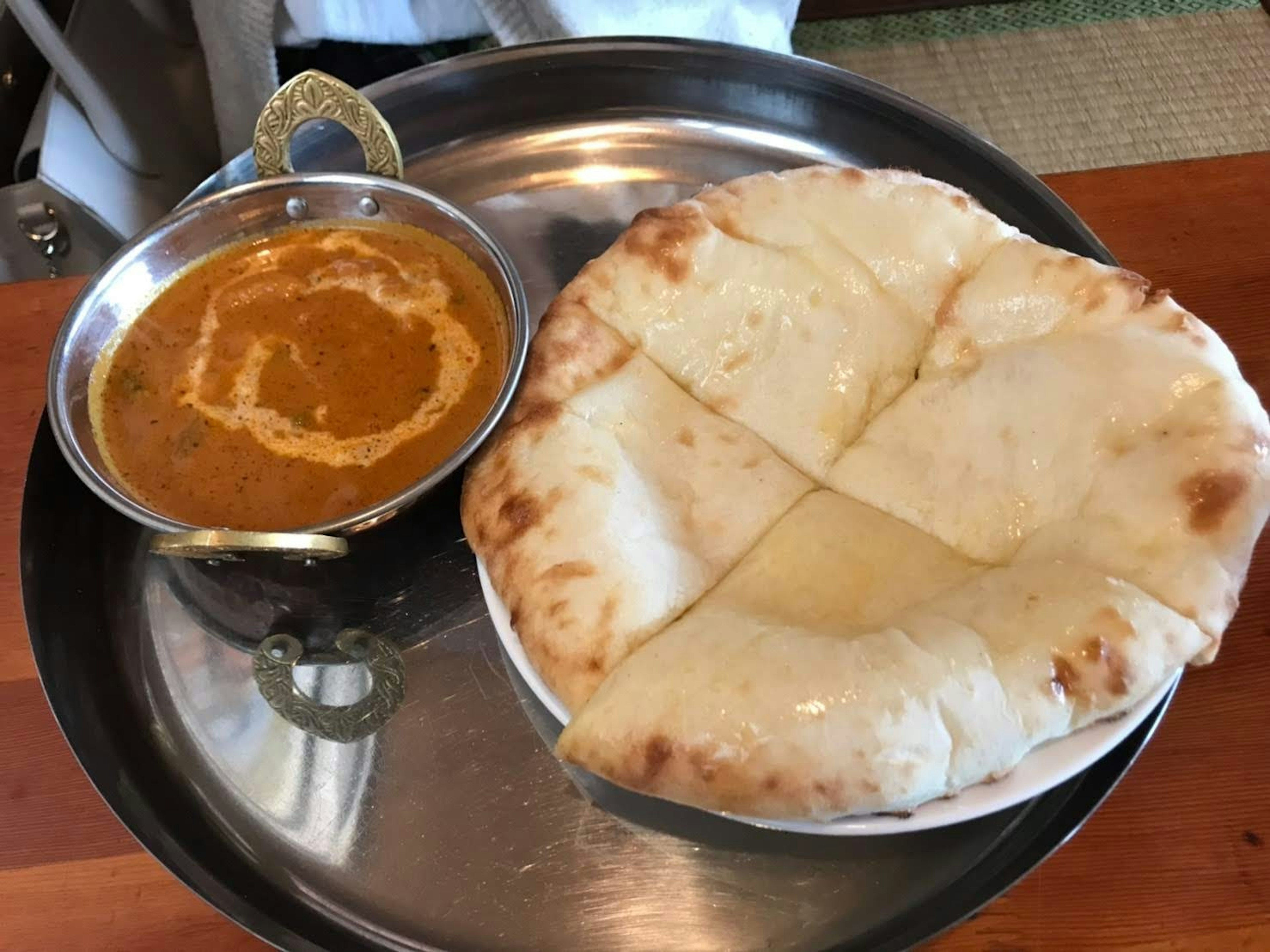 Une assiette avec du curry et du pain naan