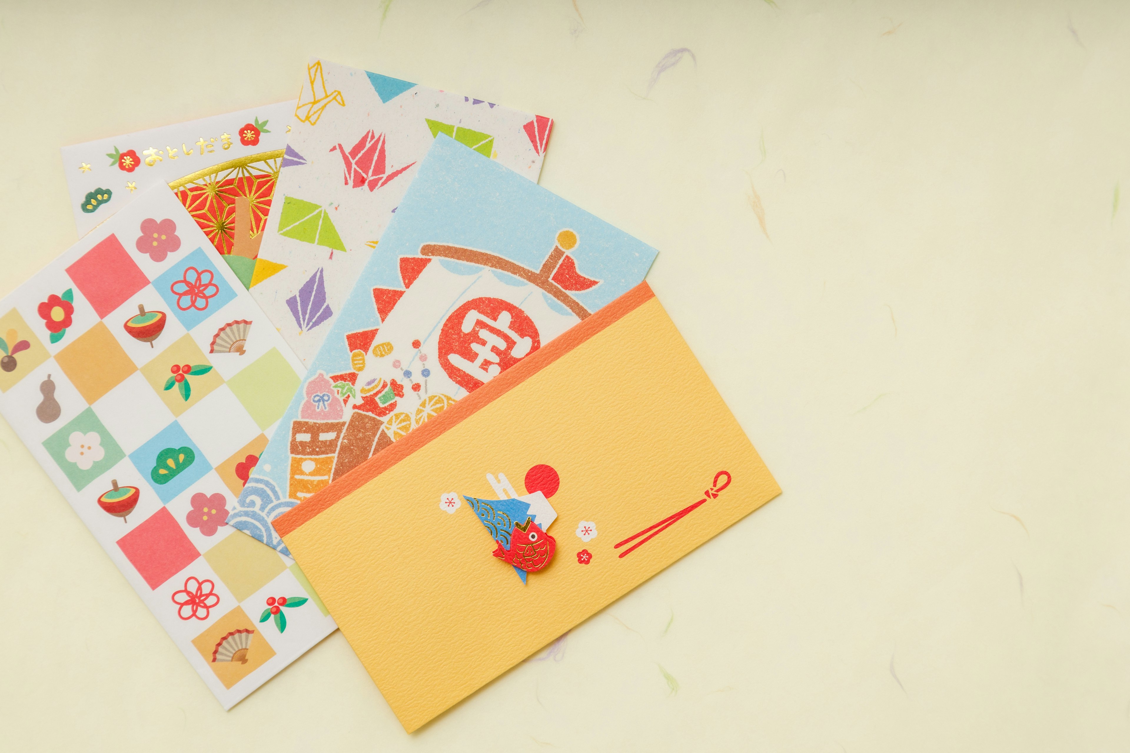 Colorful patterned stationery and an orange envelope are displayed