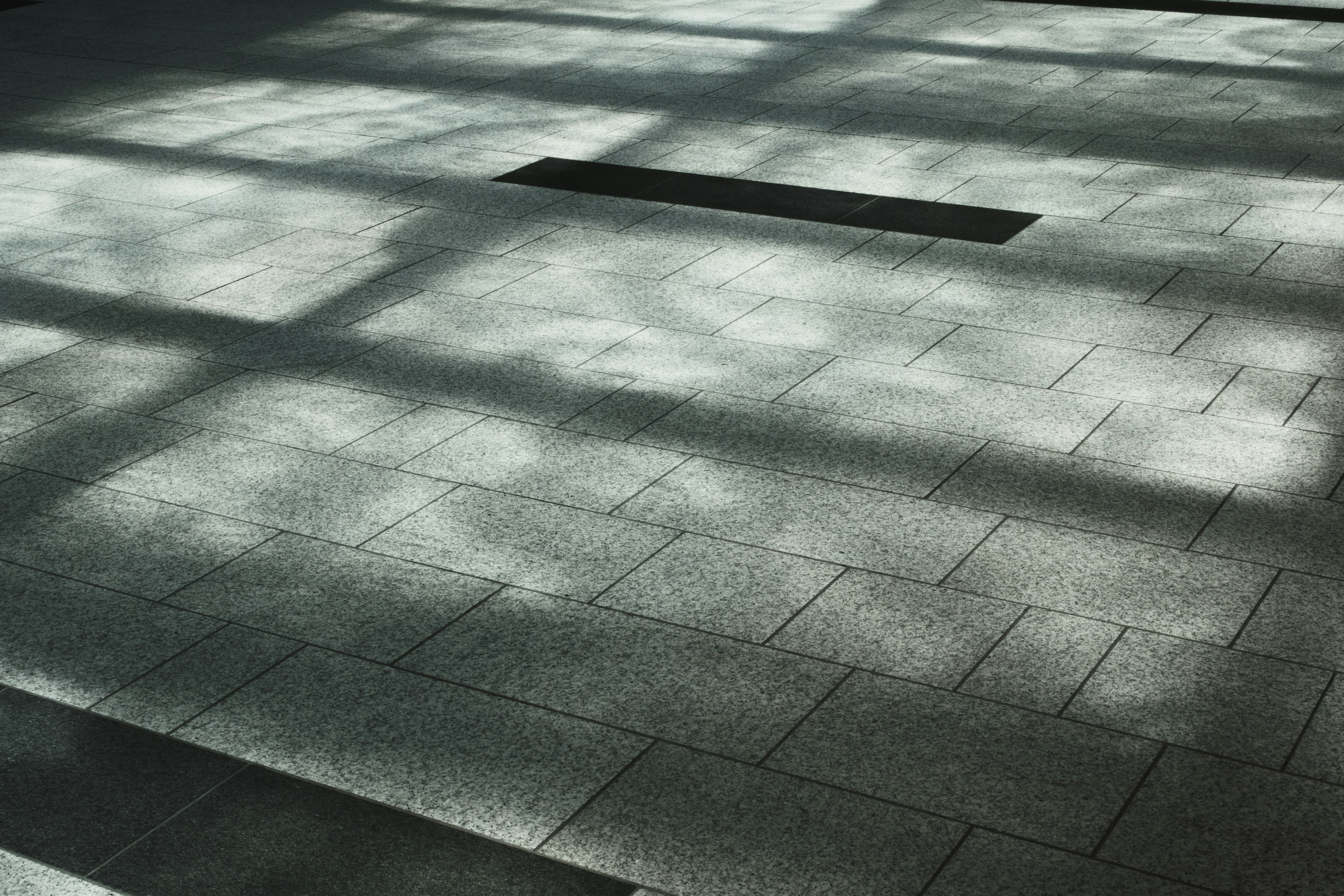 Pattern of floor tiles with light reflections and shadows