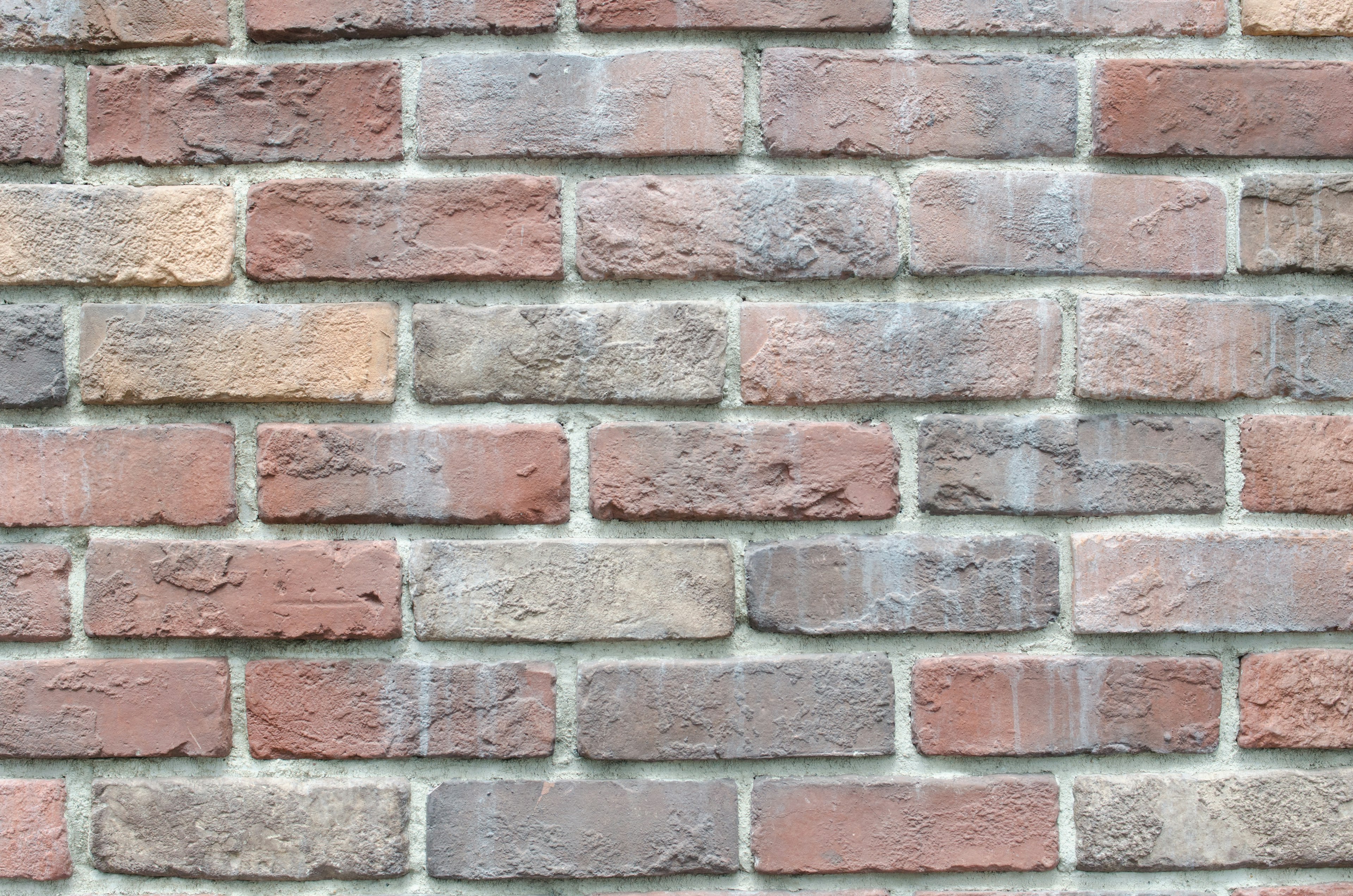 Texture of a wall made of alternating red and gray bricks