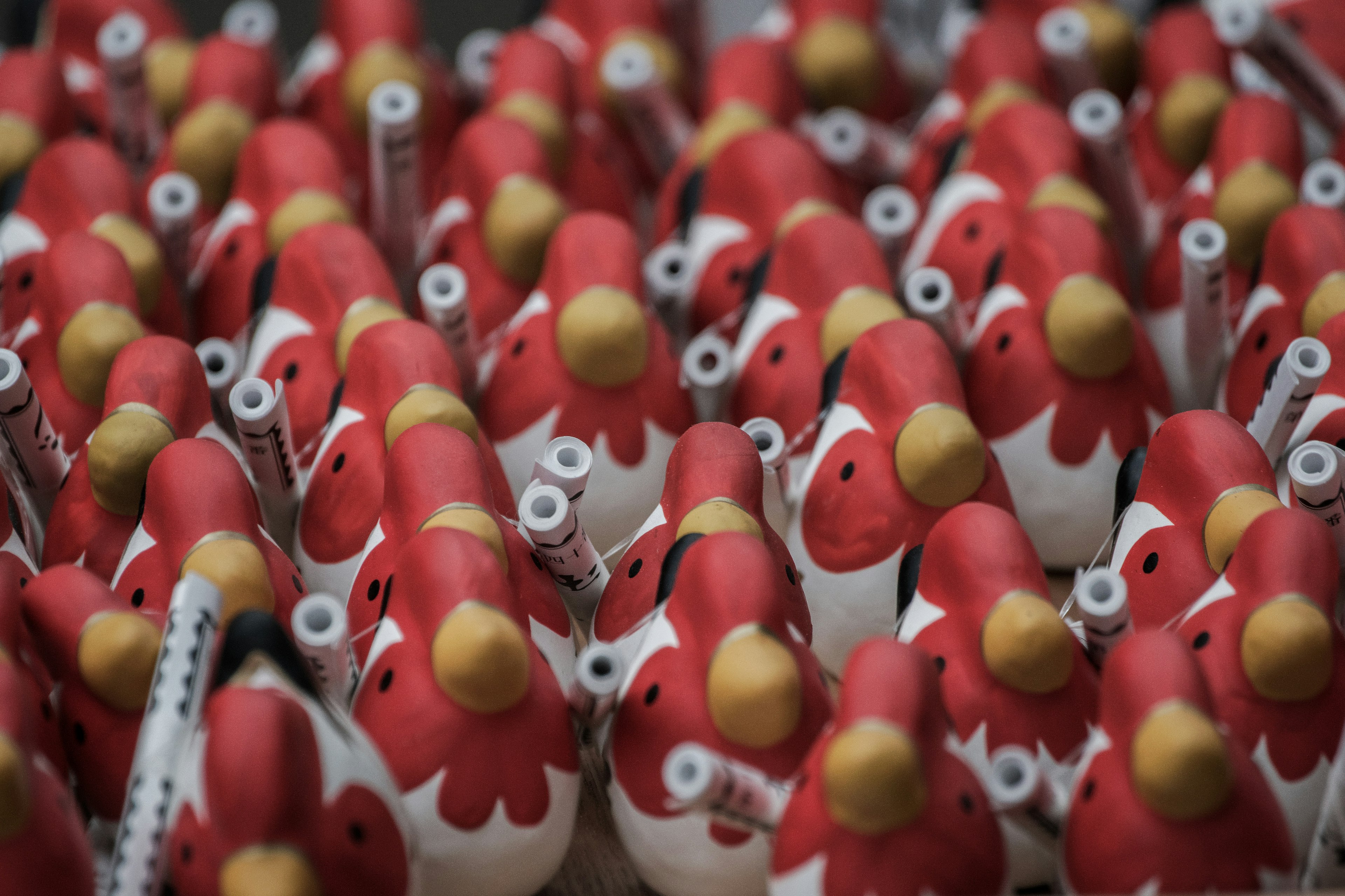 A collection of red chicken-shaped decorations clustered together