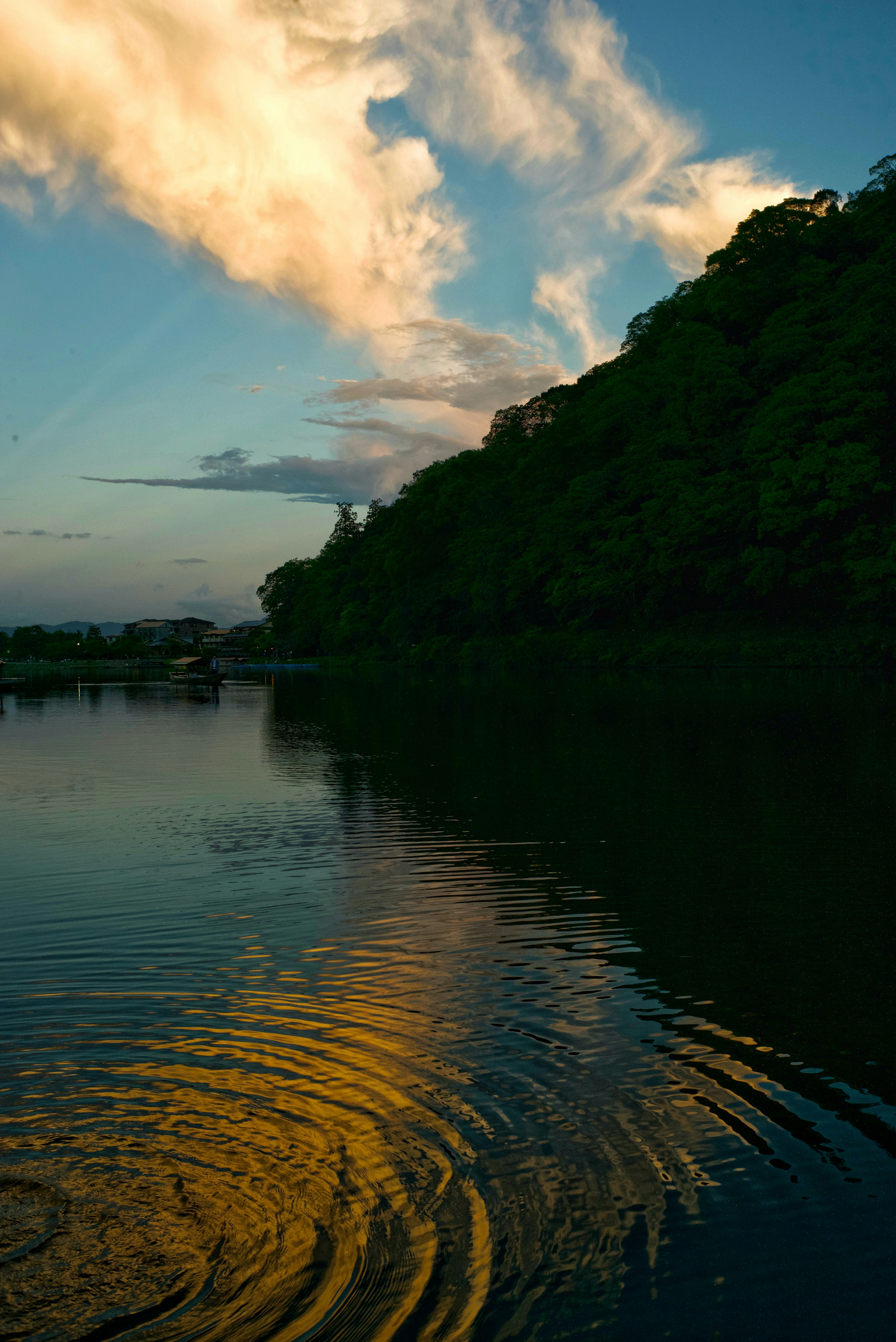 Scenic view of clouds and green trees reflected in a tranquil lake