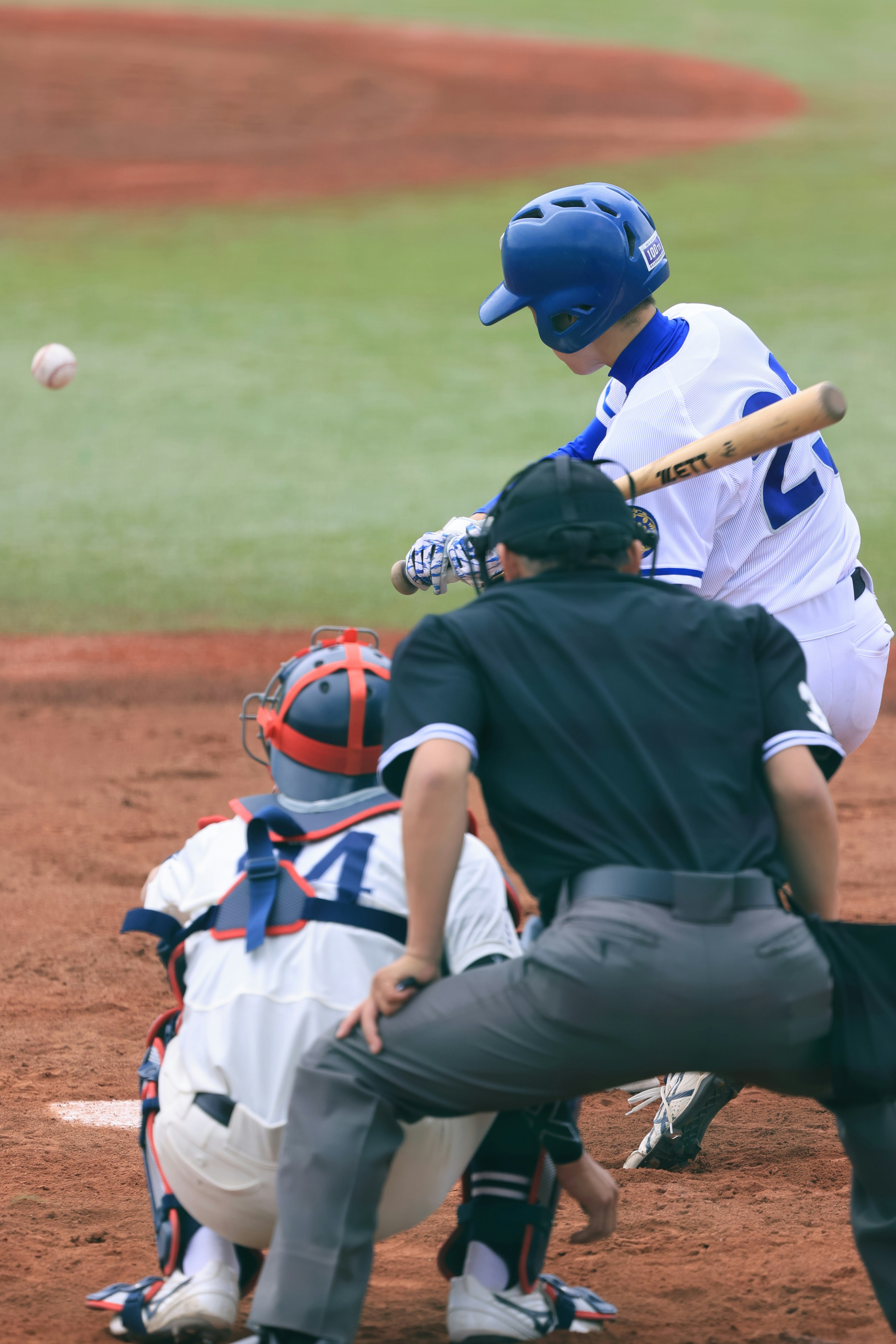 Momento in una partita di baseball battitore pronto a colpire la palla arbitro e ricevitore che osservano