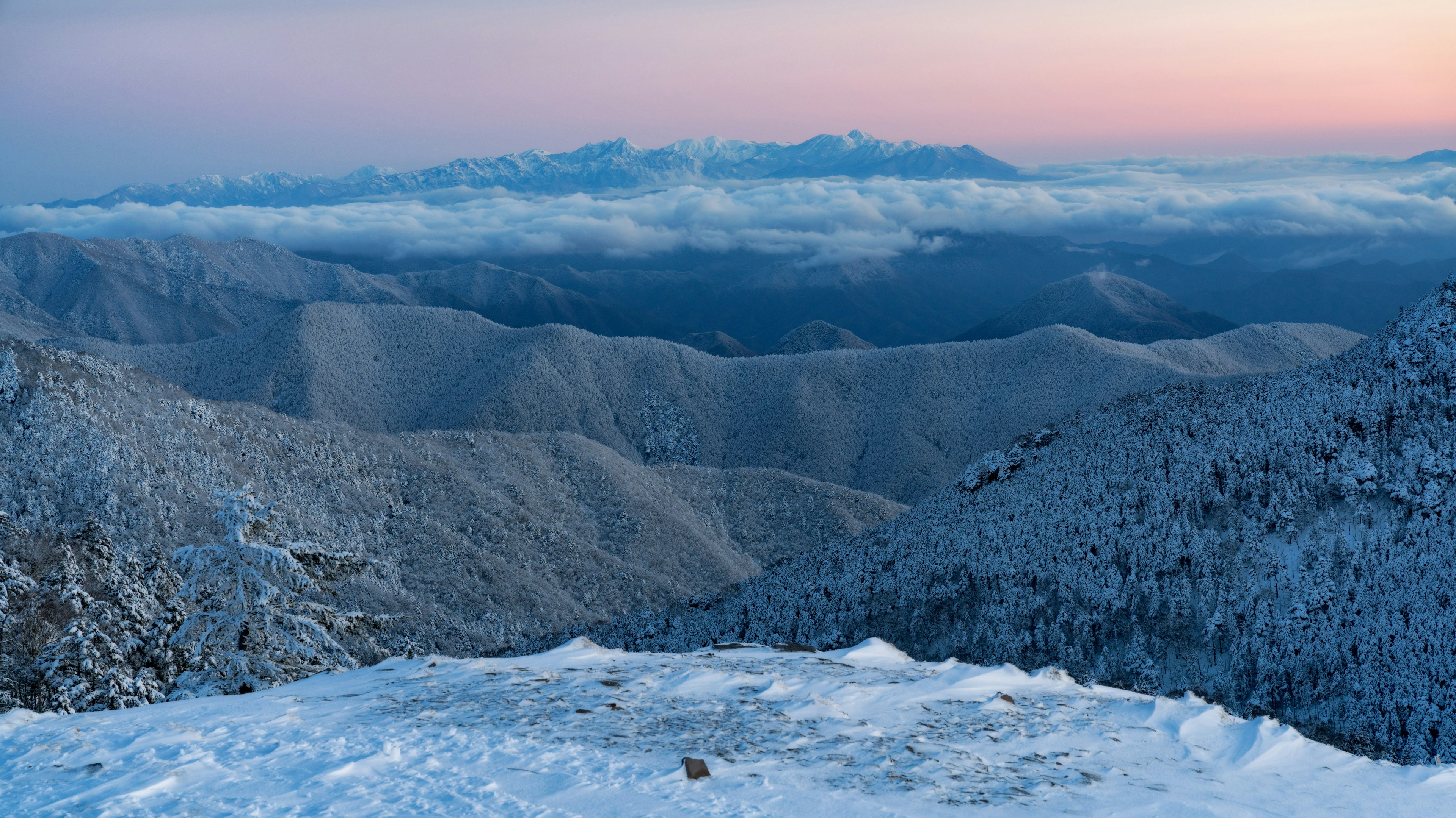 Snow-covered mountain landscape with twilight sky