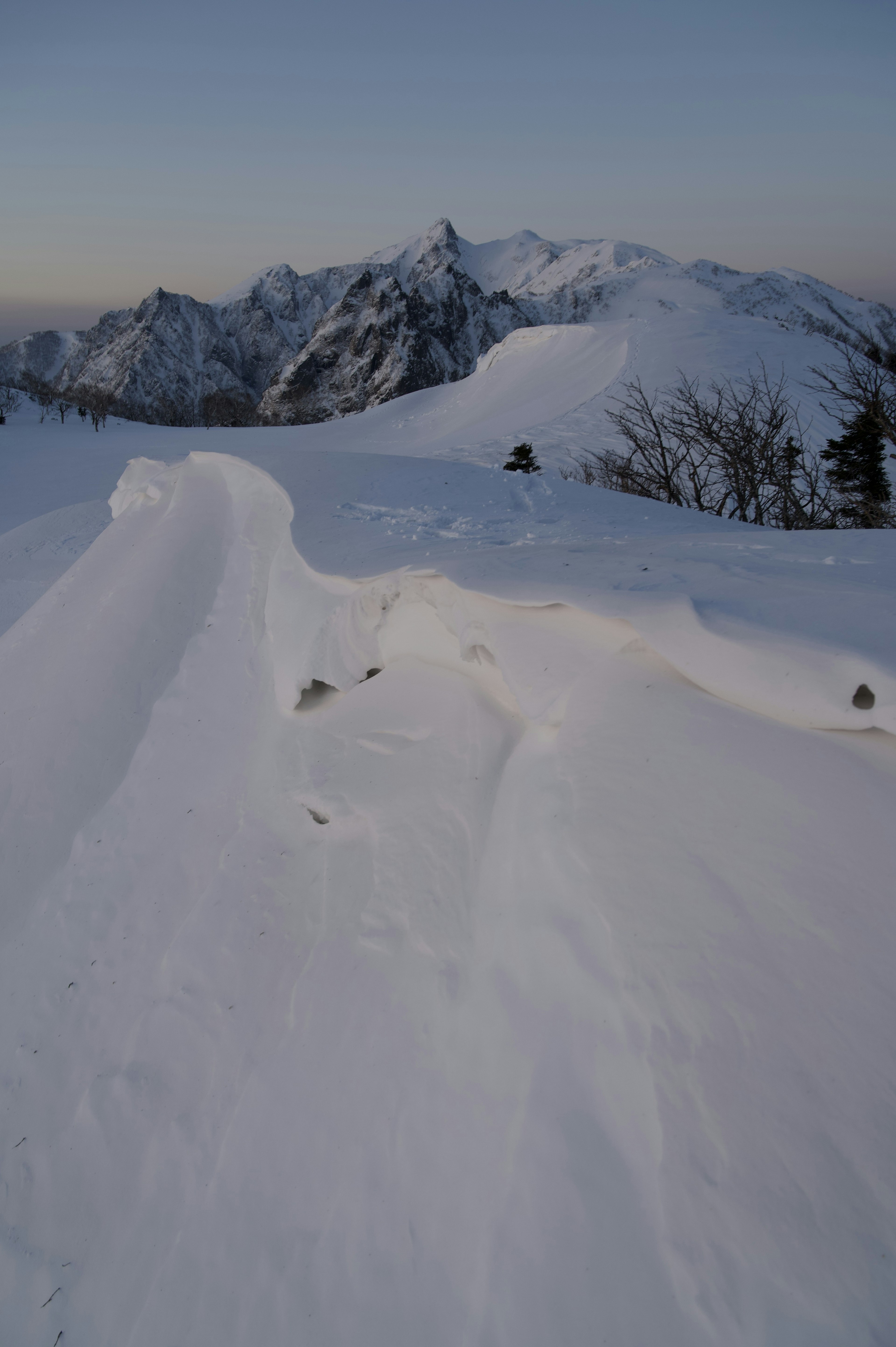 Snow-covered mountain landscape with distant peaks visible