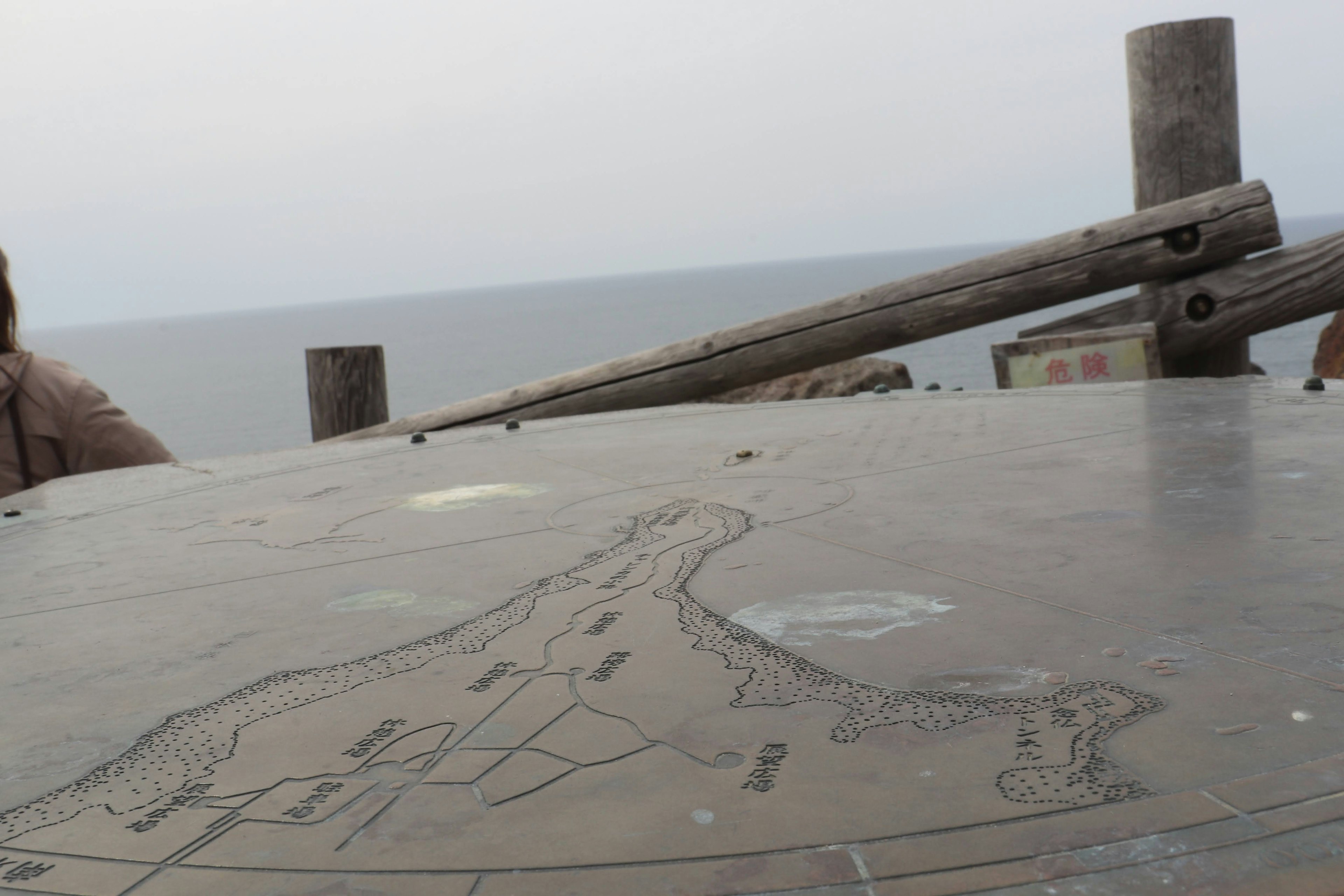 Table with engraved map overlooking the sea