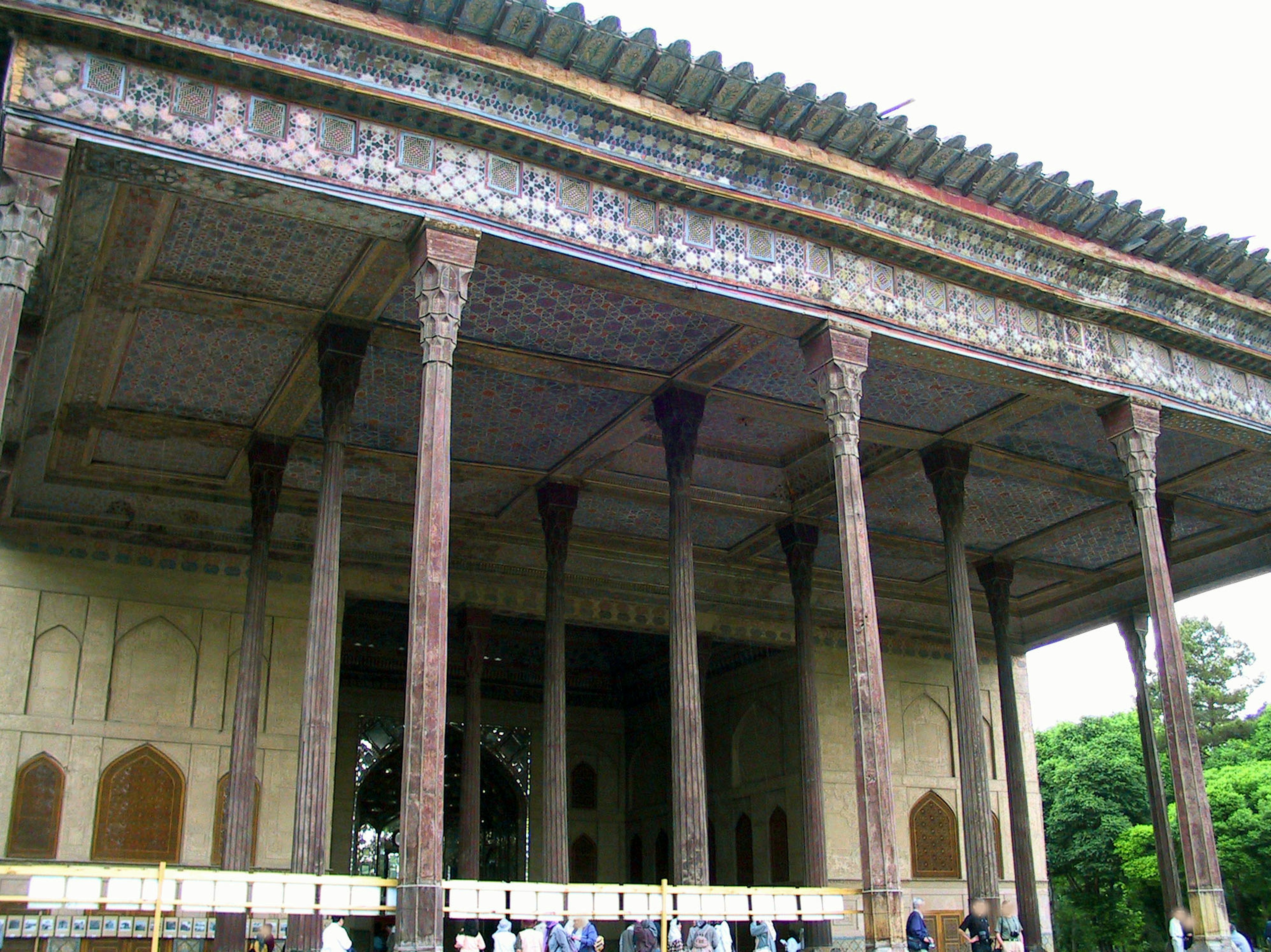 Exterior view of a grand building with ornate columns and decorations