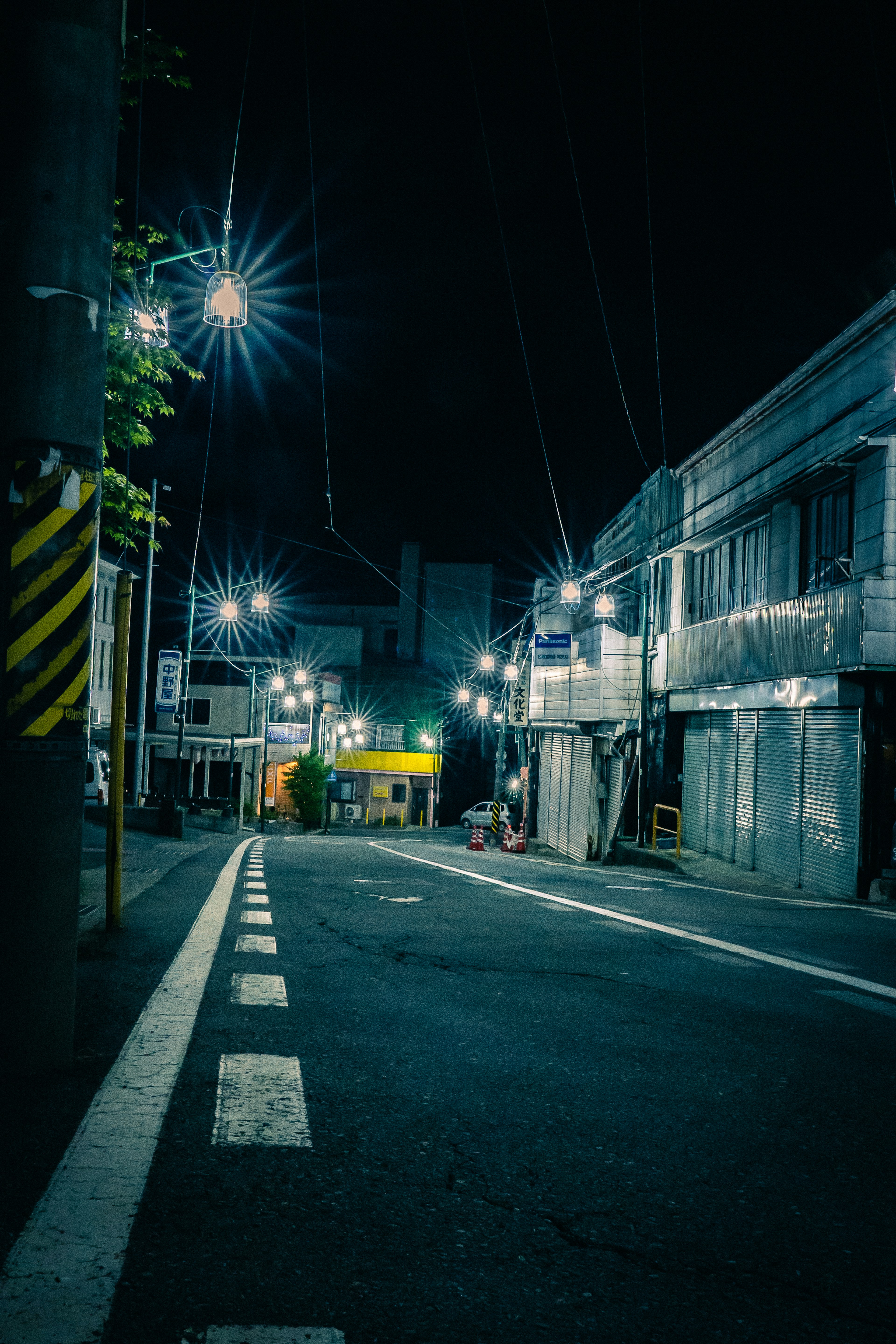 Quiet nighttime street with old buildings and streetlights