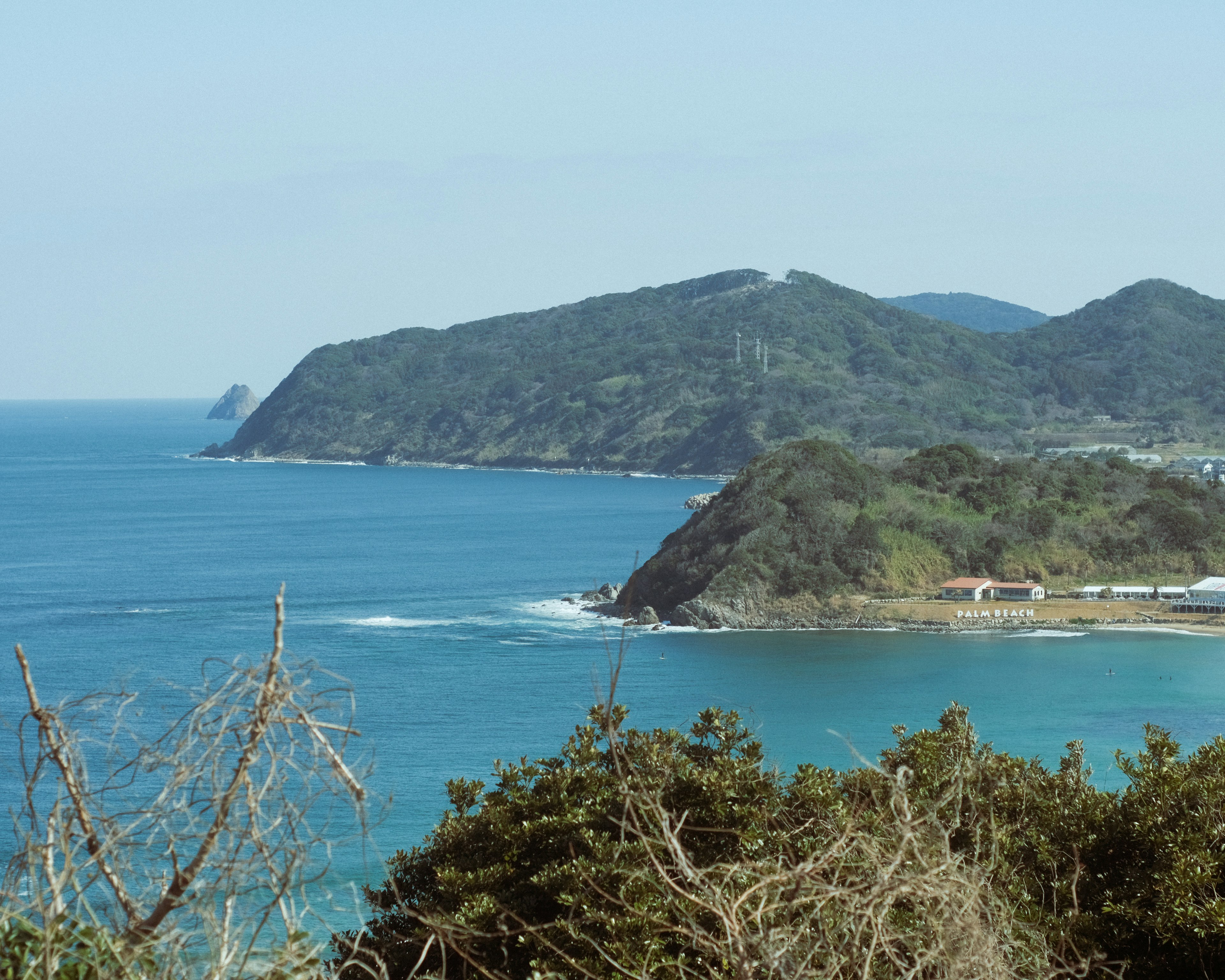 Vista escénica del océano azul y colinas verdes