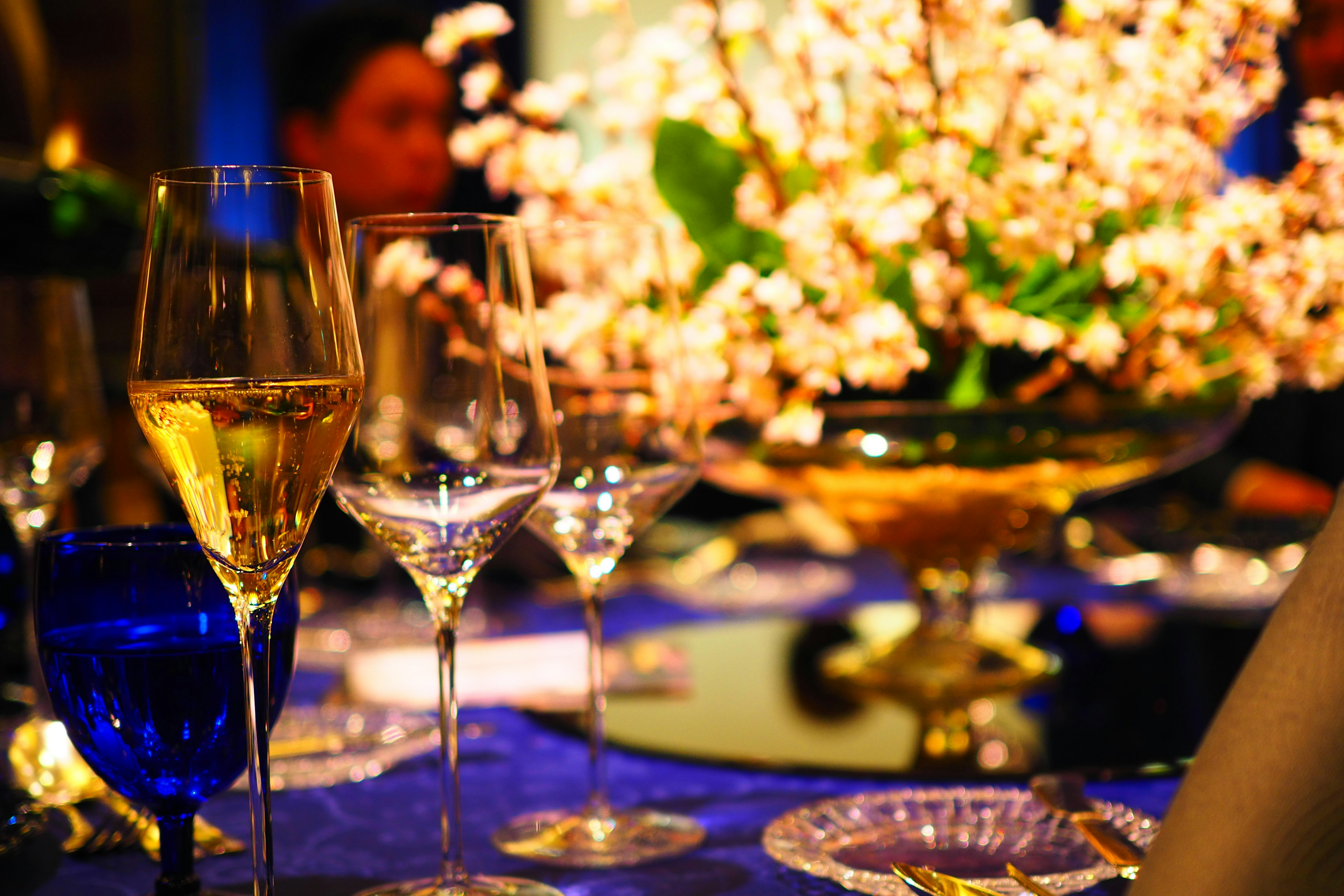 Elegant table setting featuring champagne glasses and a floral arrangement