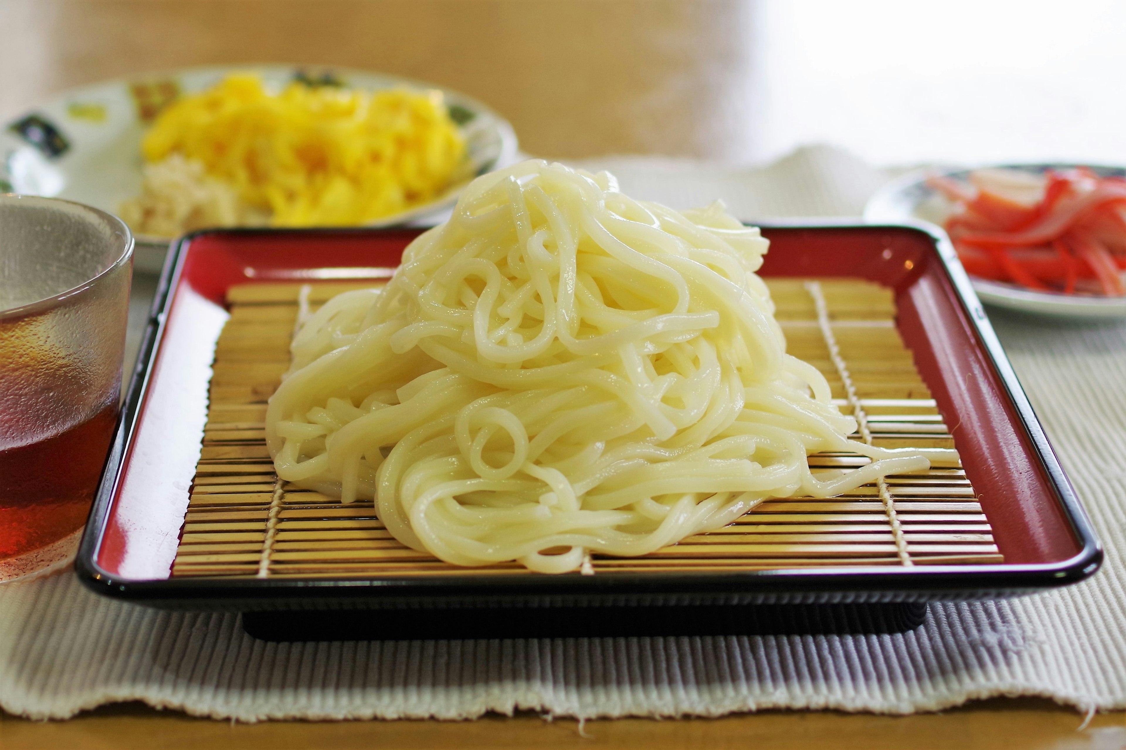 A mound of white noodles served on a traditional Japanese plate