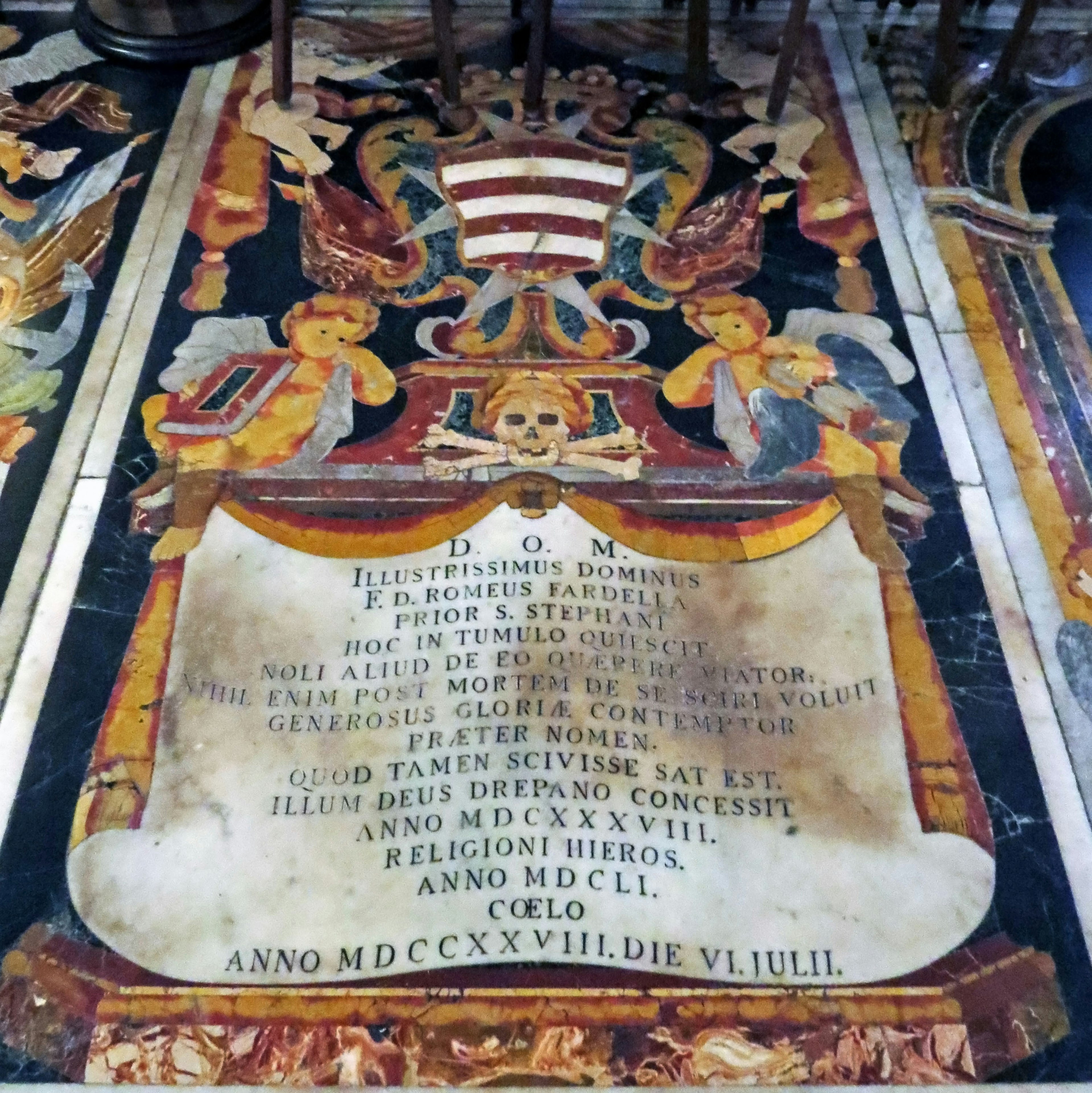 Ornately decorated floor tomb with Latin inscription