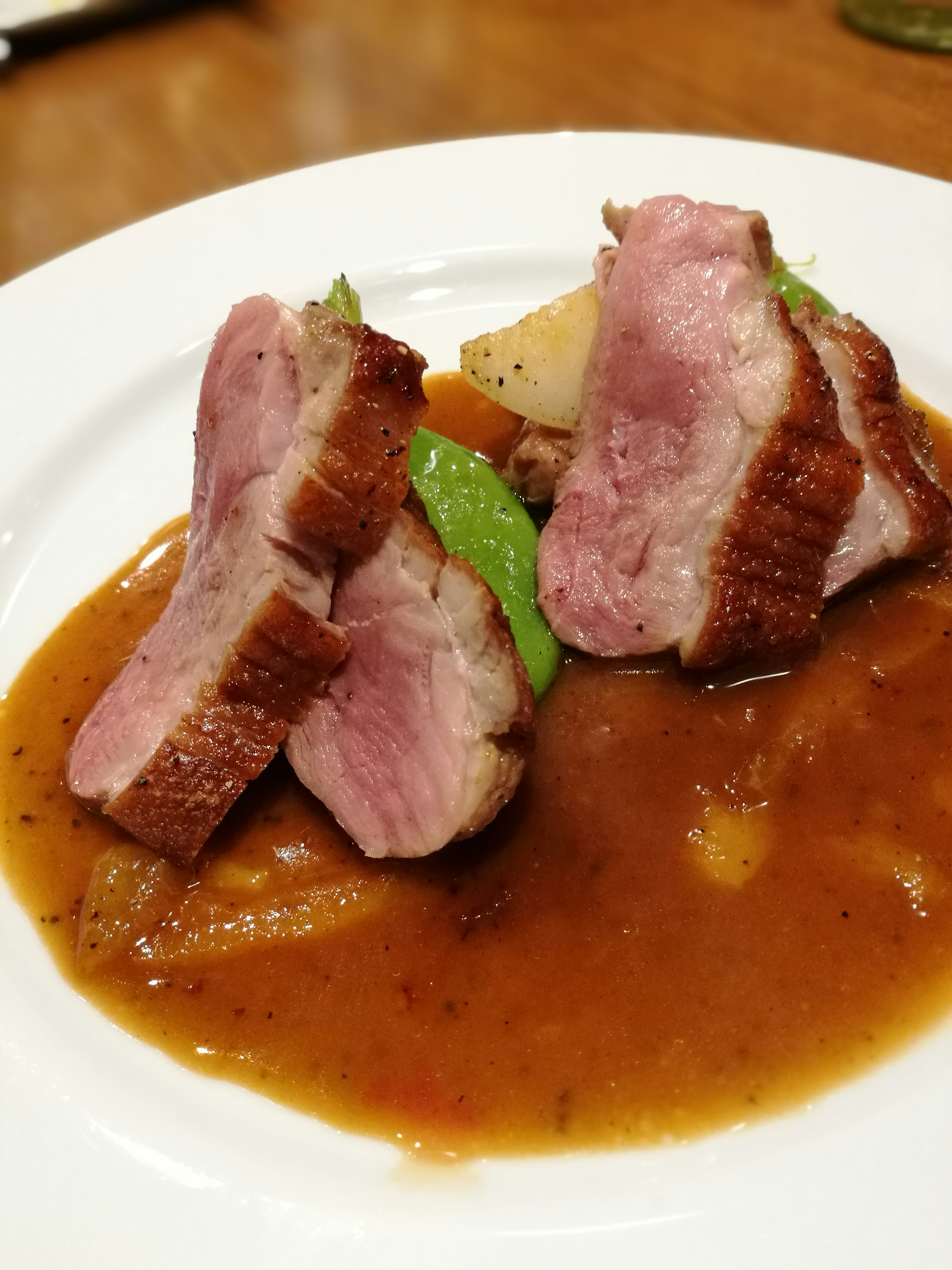 Delicious duck dish plated with sauce and vegetables