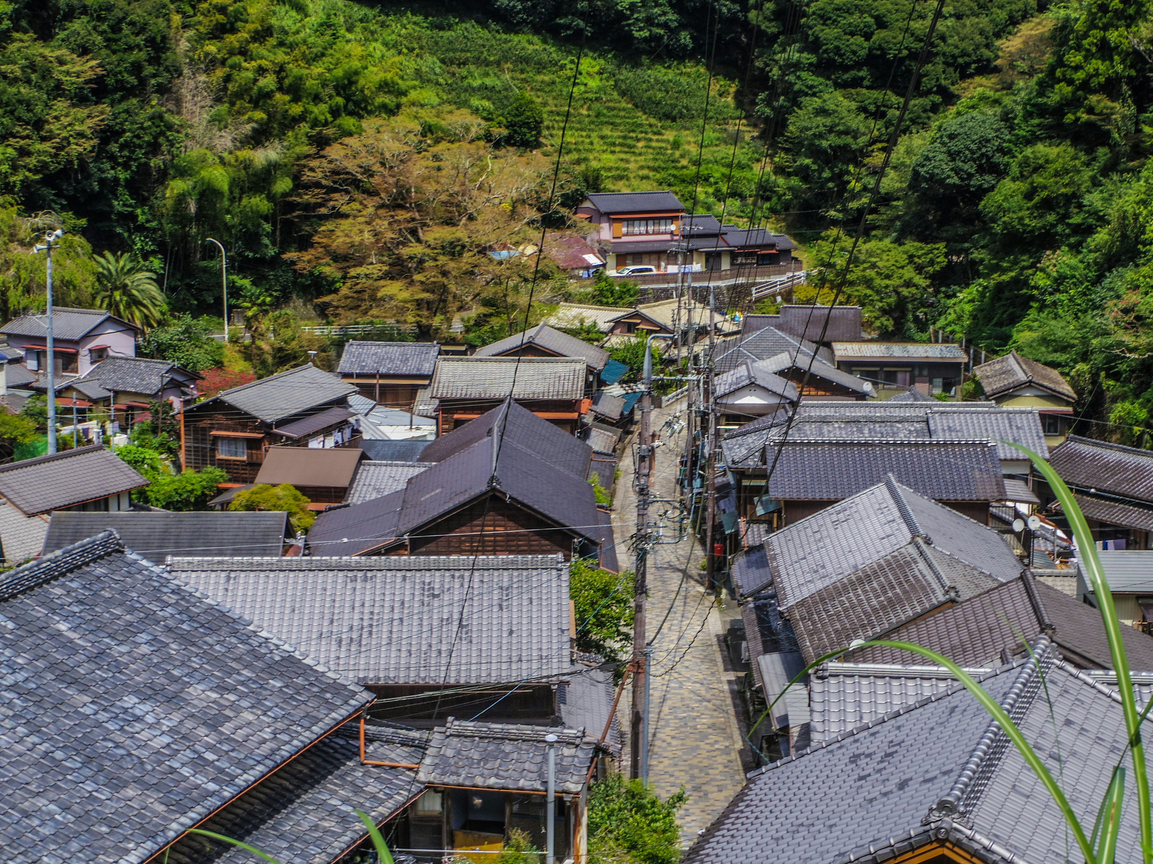 A scenic view of a traditional village nestled in the mountains with old houses