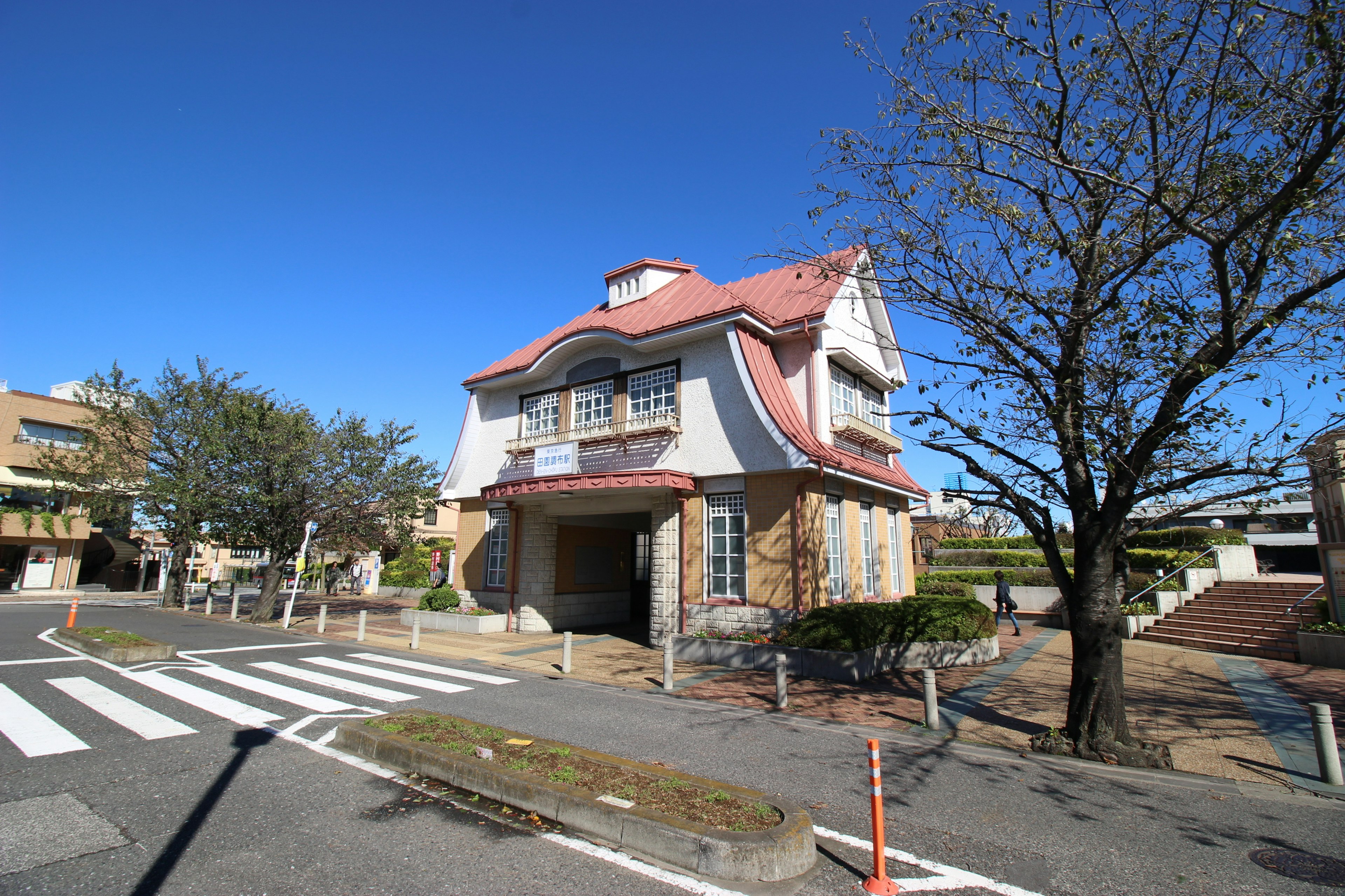 Unique designed house under blue sky with surrounding trees