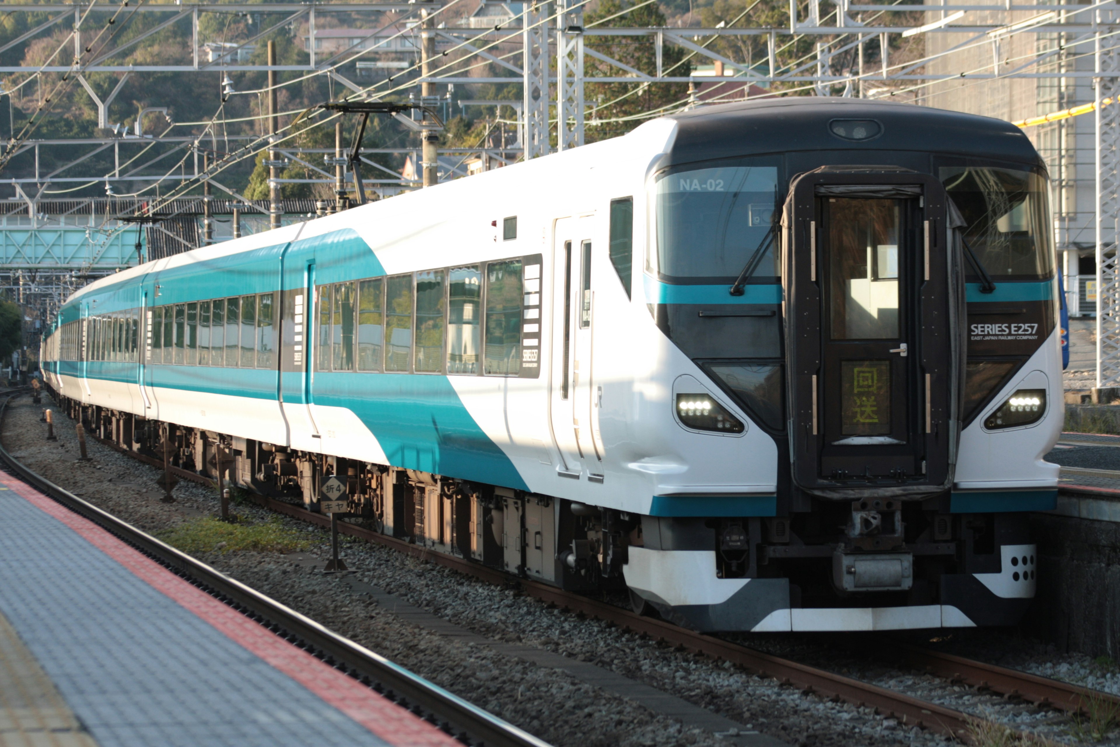 Modern train with blue and white design stopped at a station