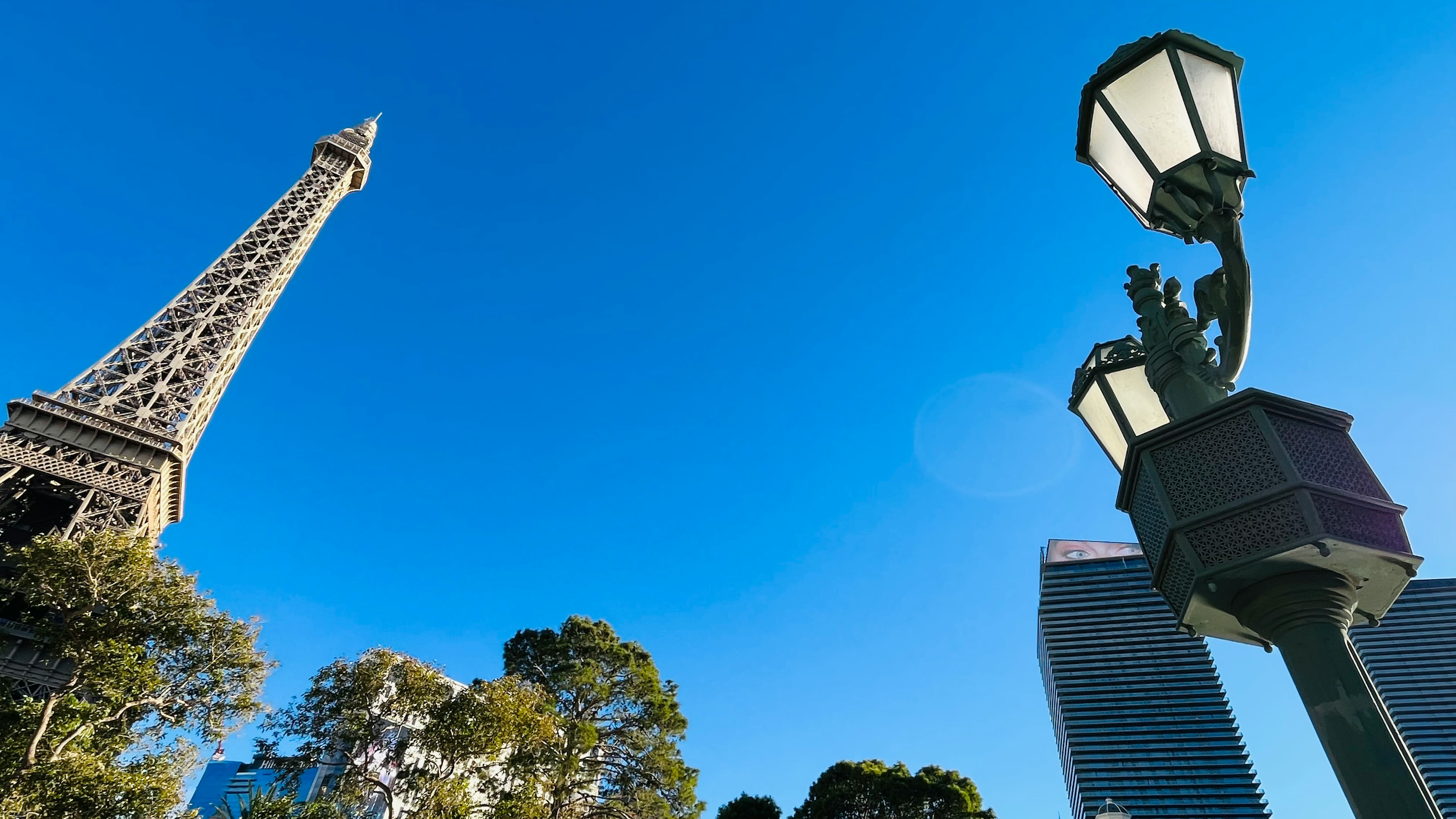 Eiffel Tower and street lamp against a clear blue sky