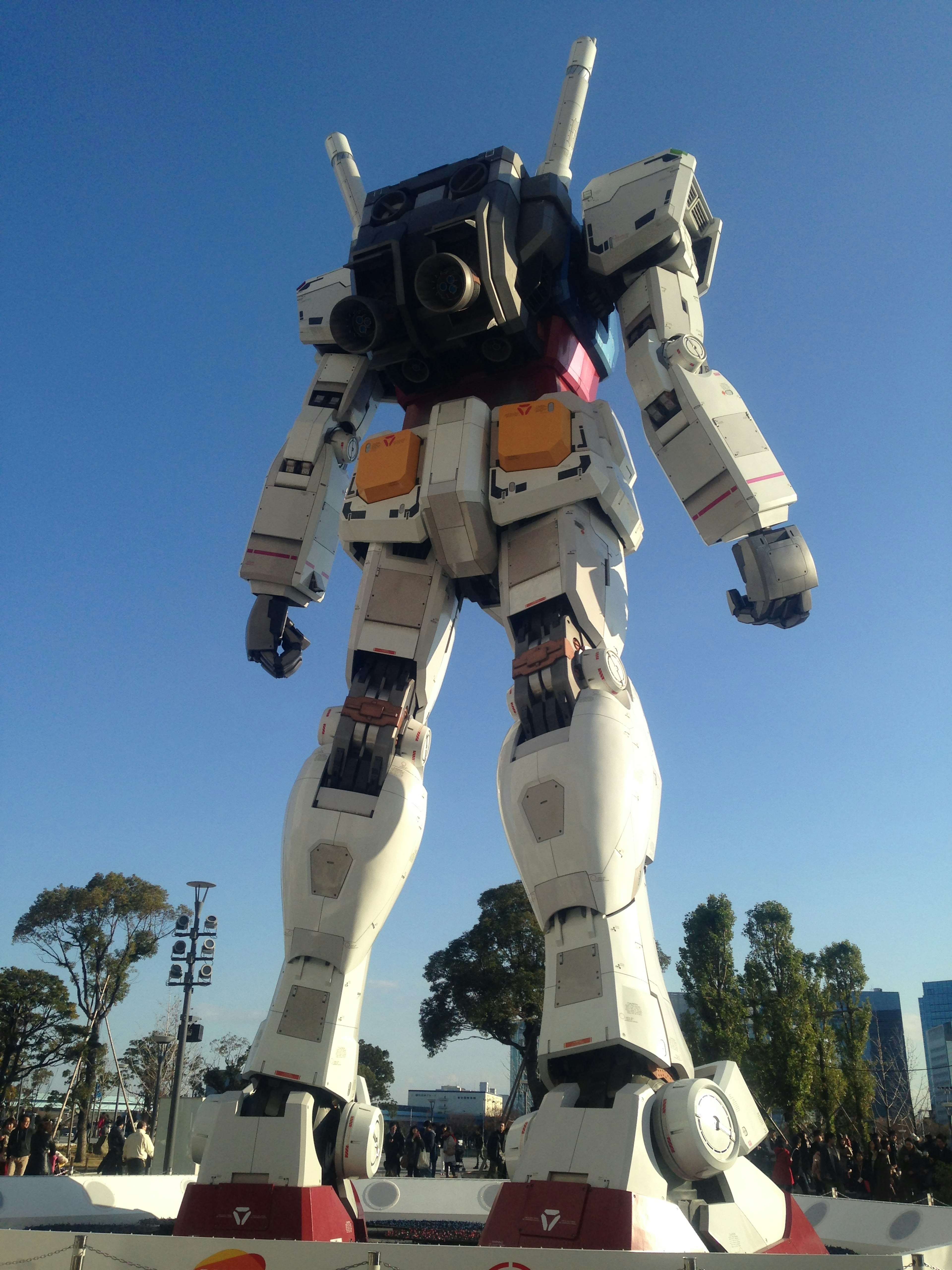 Giant robot standing under a blue sky