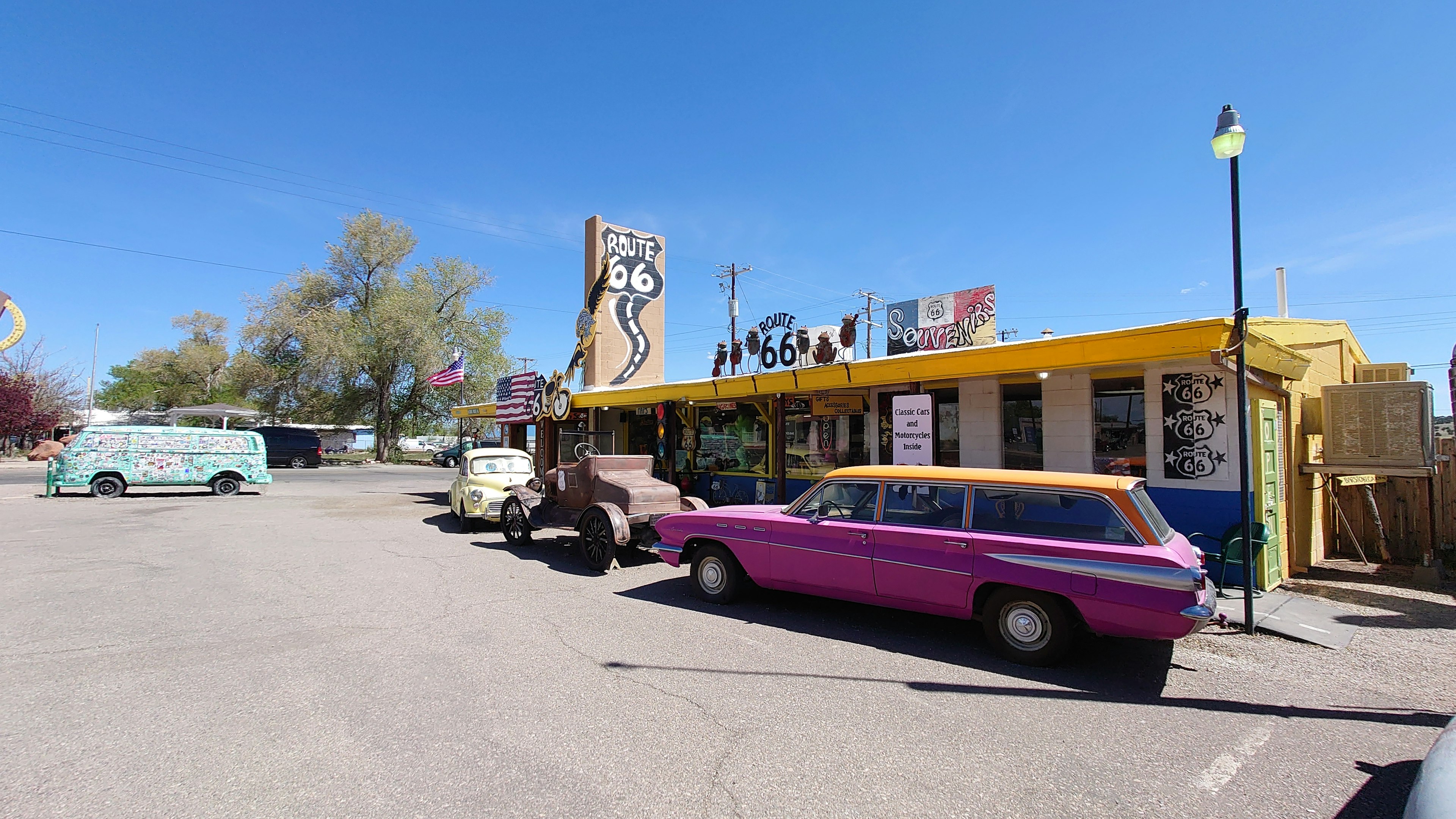 Colorful restaurant exterior with vintage cars in the foreground