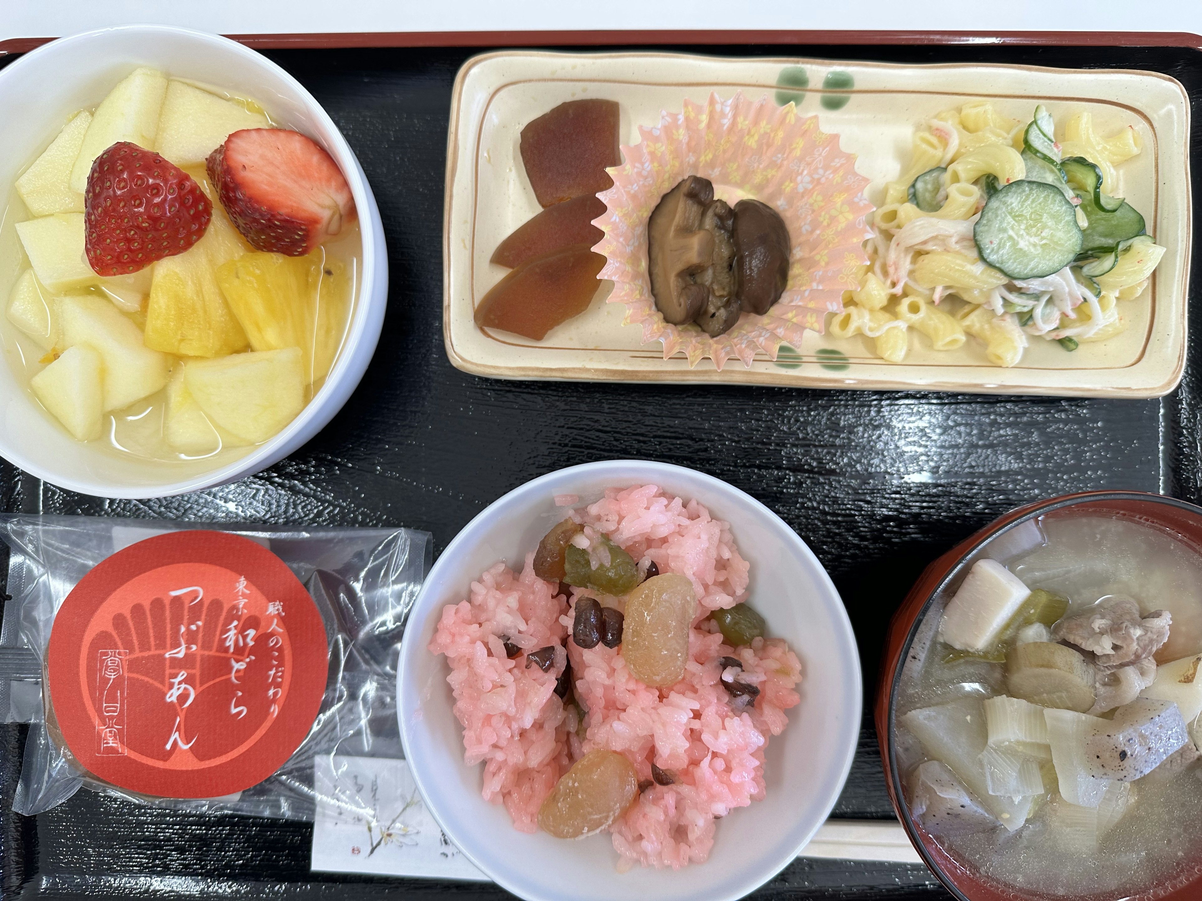 Colorful Japanese meal plate featuring various dishes and desserts