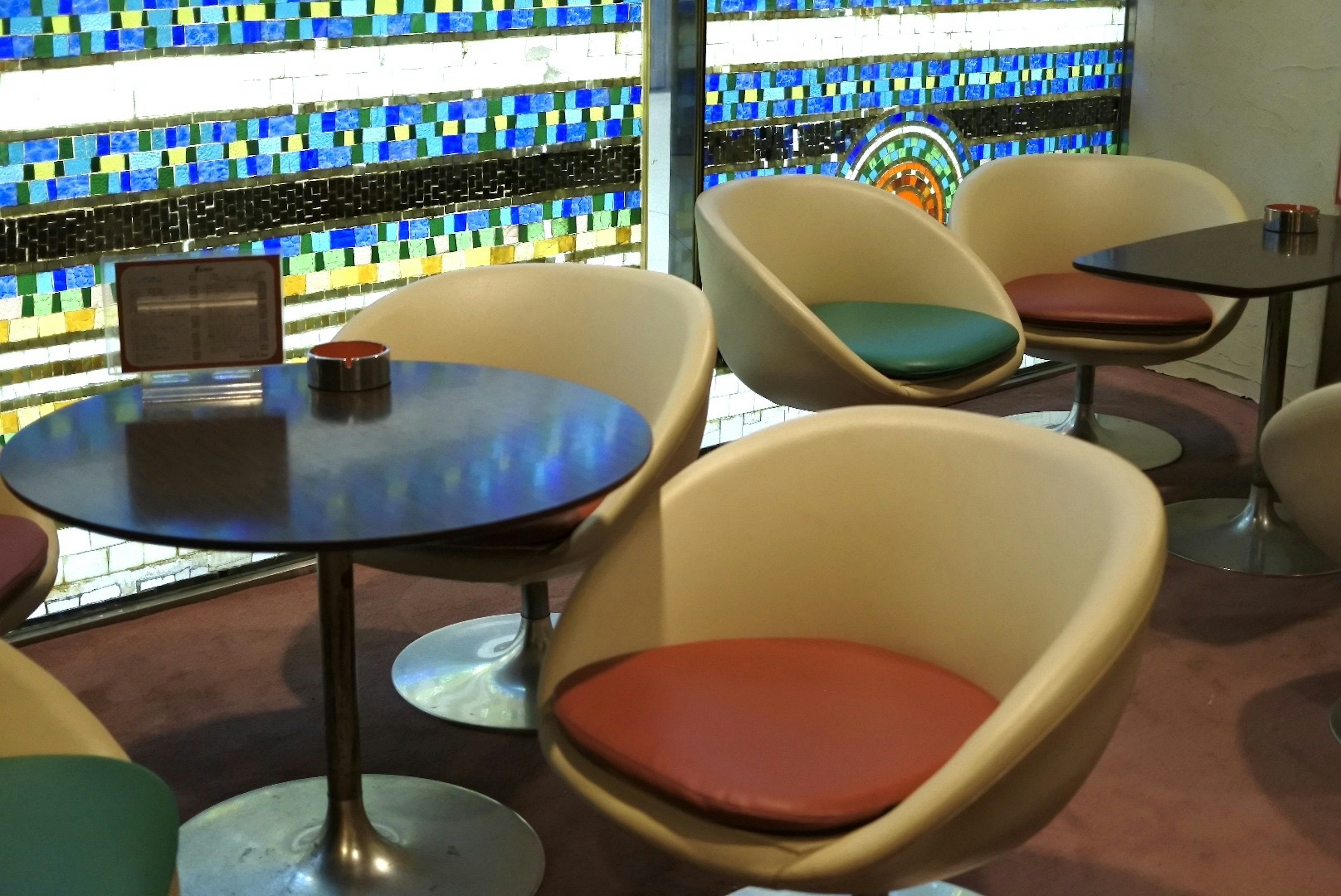 Modern cafe interior with colorful window unique chair and table design