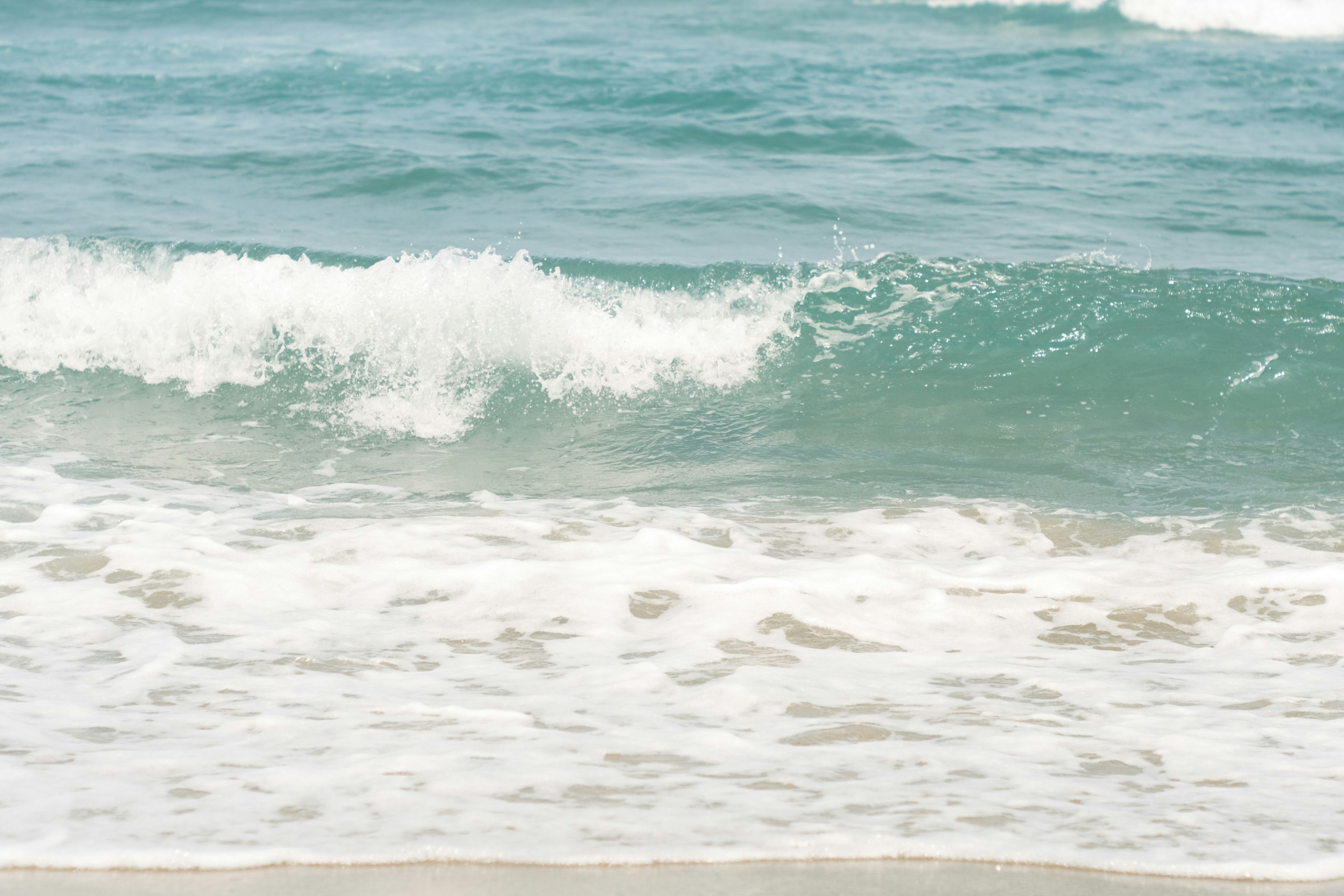 Gentle ocean waves lapping against a sandy beach