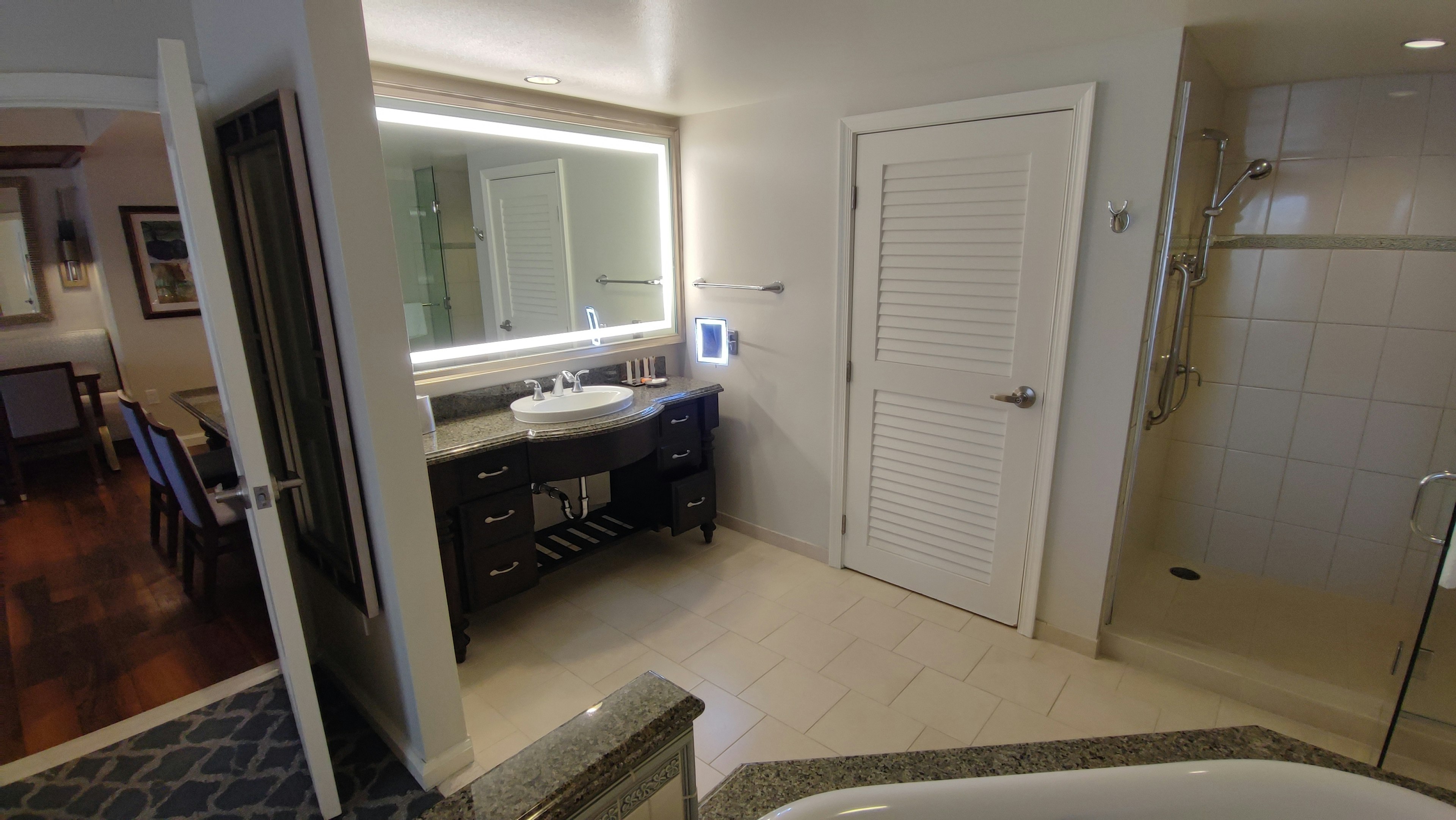 Modern bathroom interior featuring a sink and shower with bright lighting and clean design