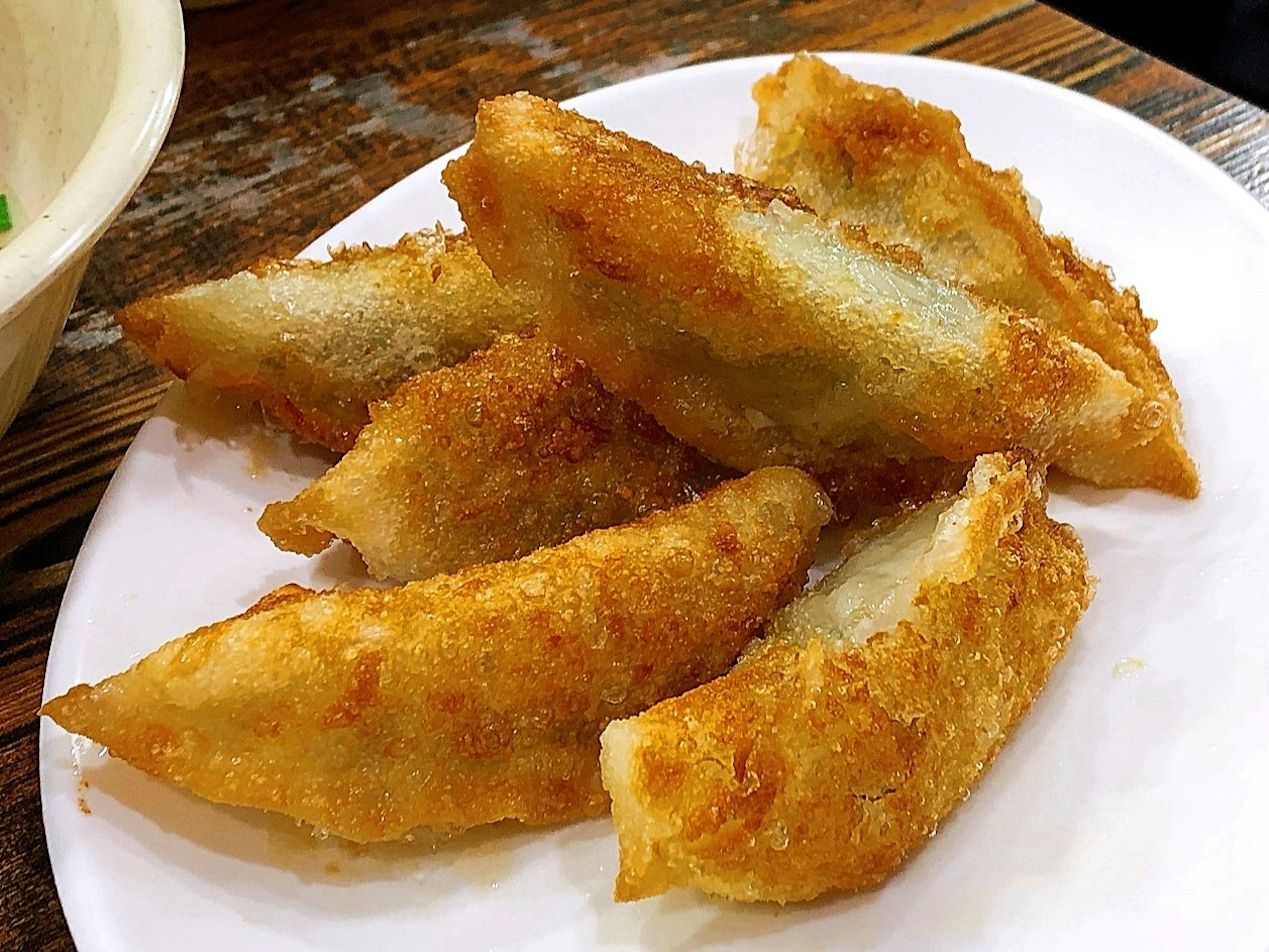 A plate of crispy fried dumplings arranged neatly