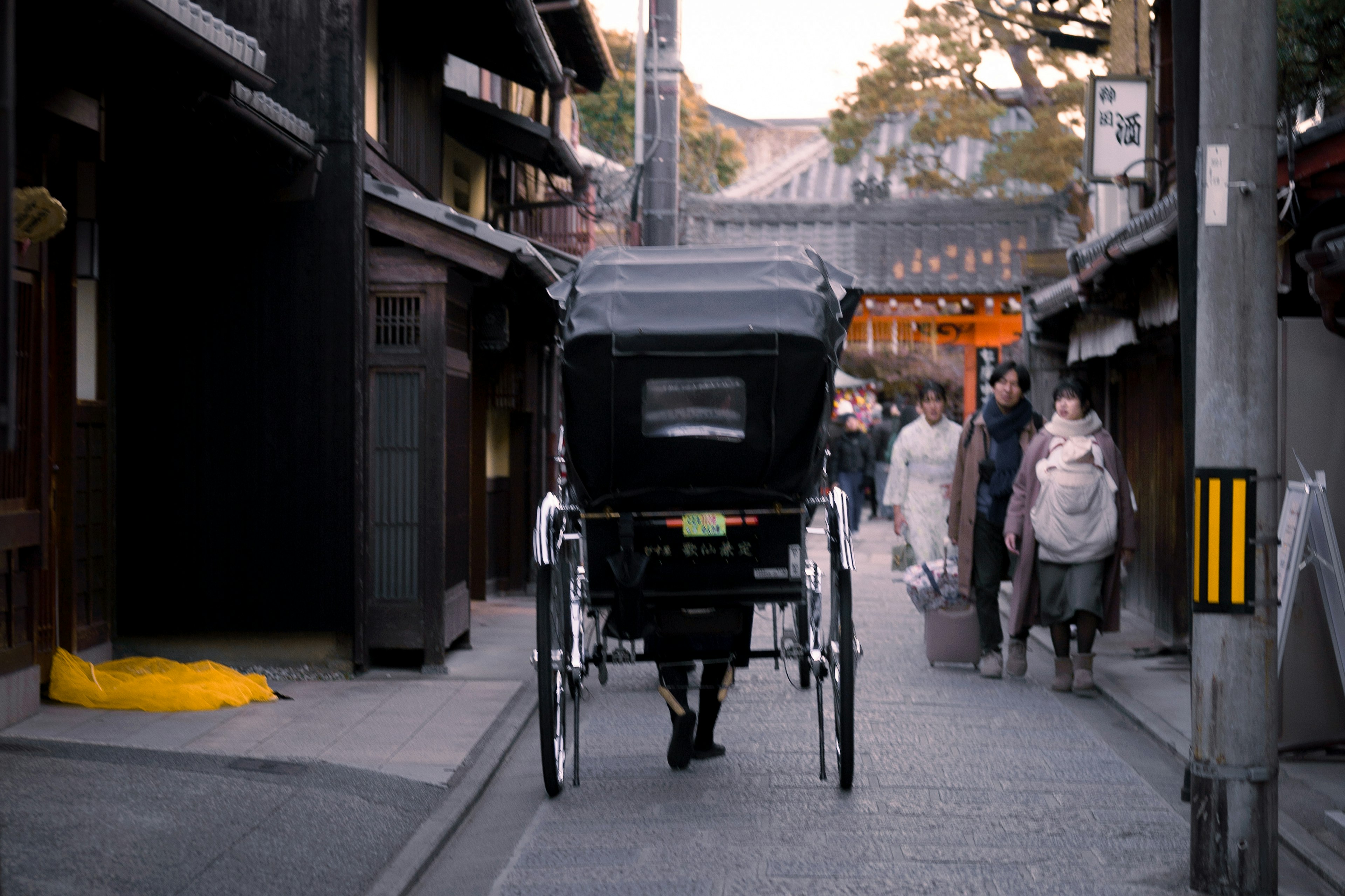 Rickshaw passing through an old street with people