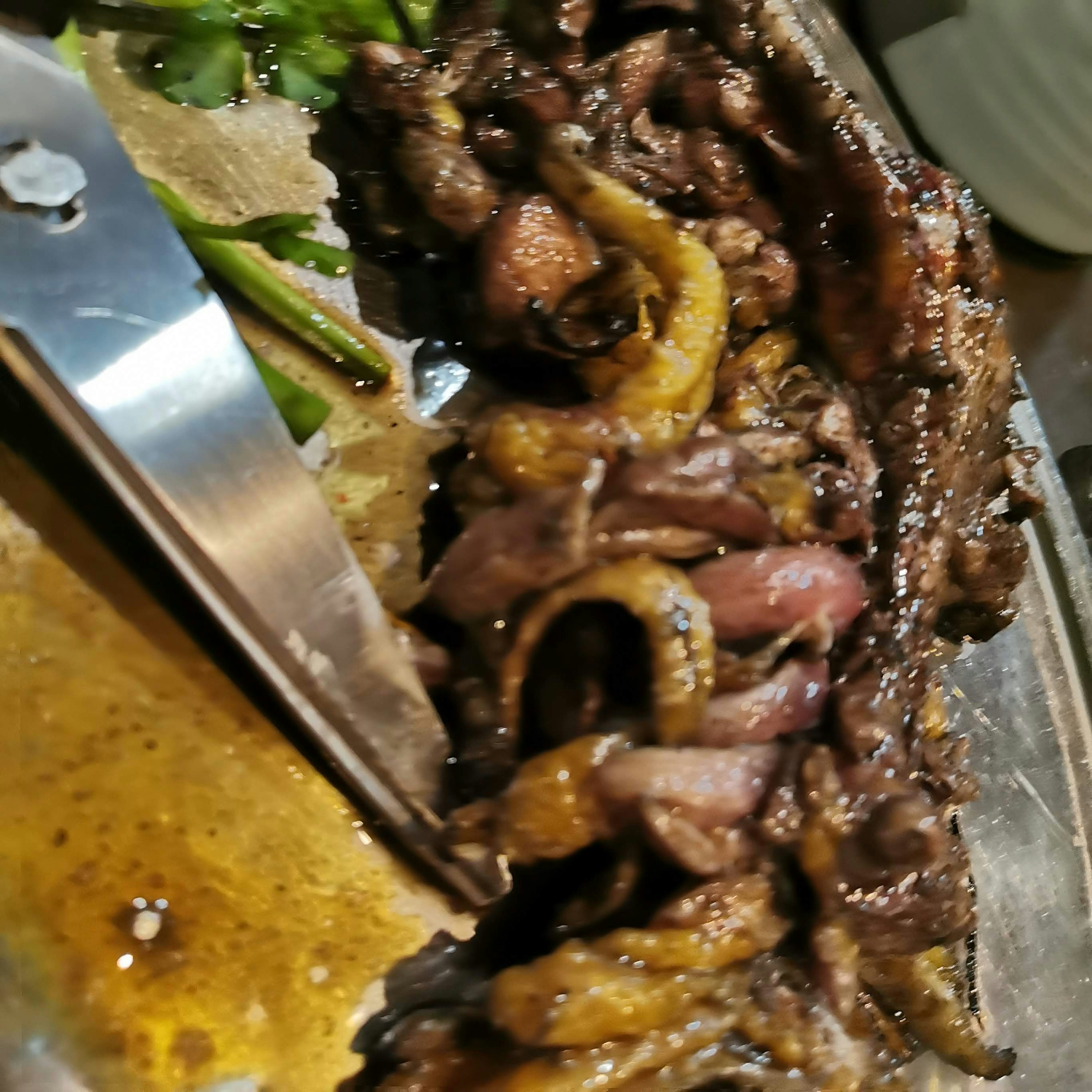 Close-up of a dish featuring grilled meat and vegetables