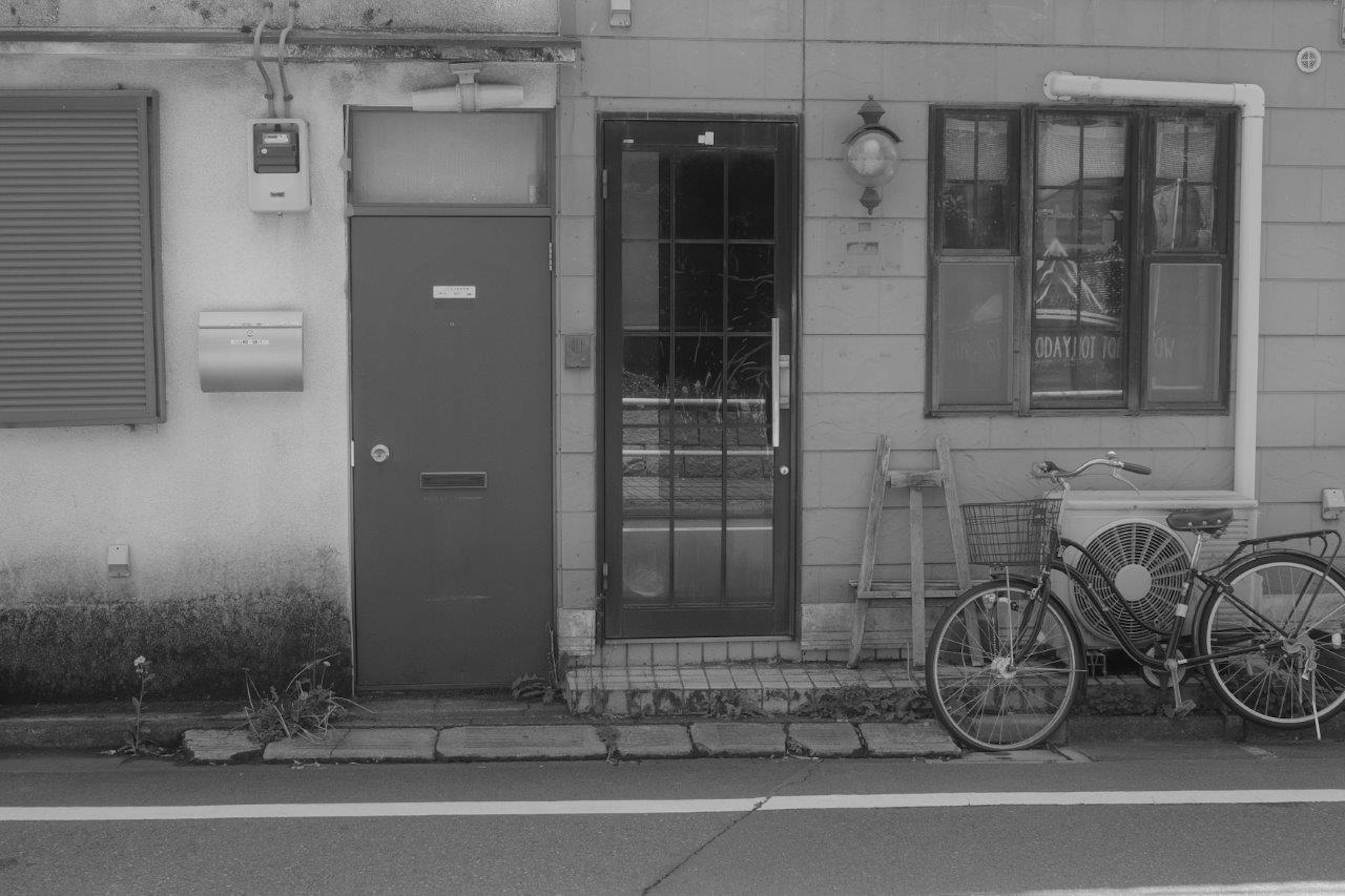 Entrance of an old house with a door and window Bicycle parked on the street