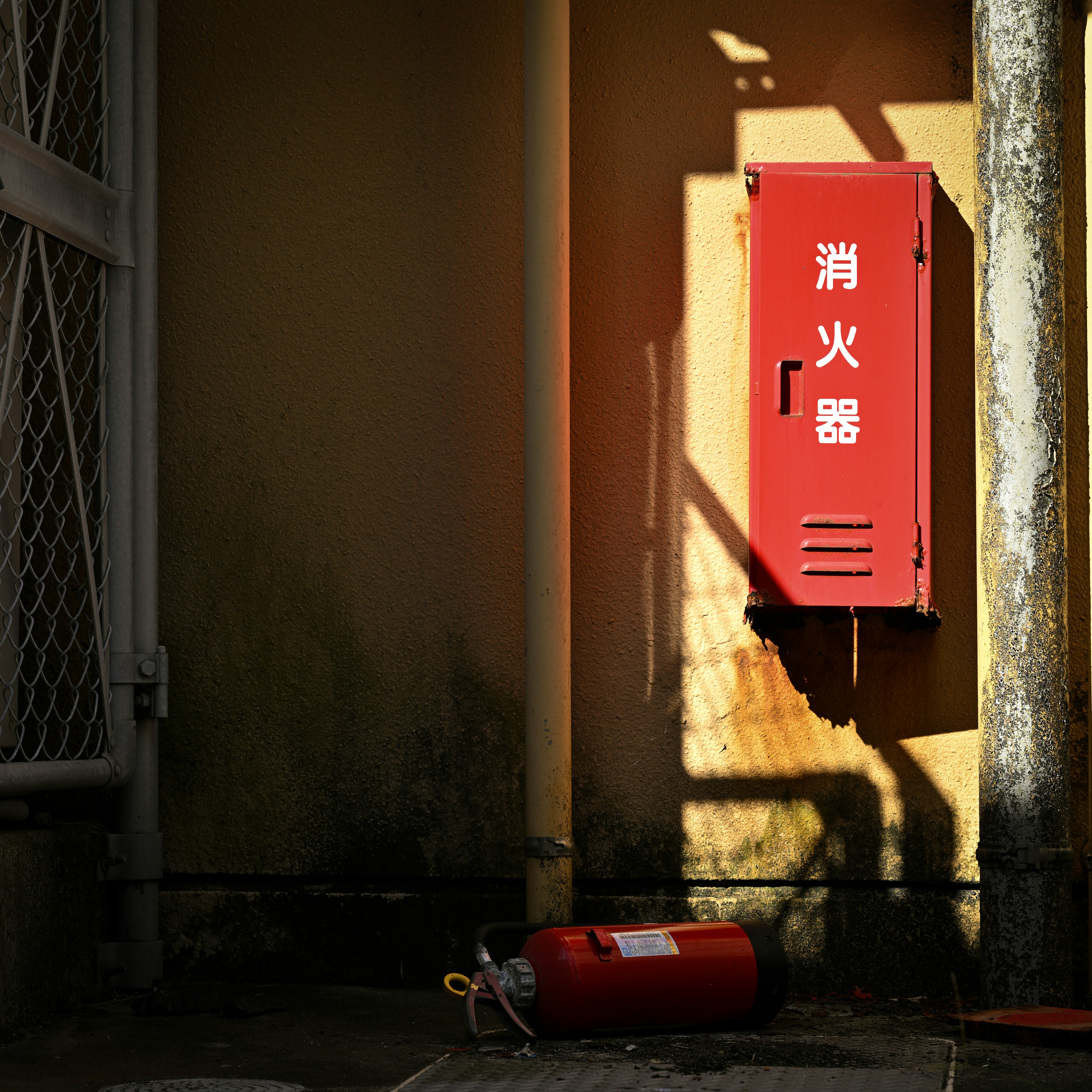 A red fire extinguisher mounted on a wall