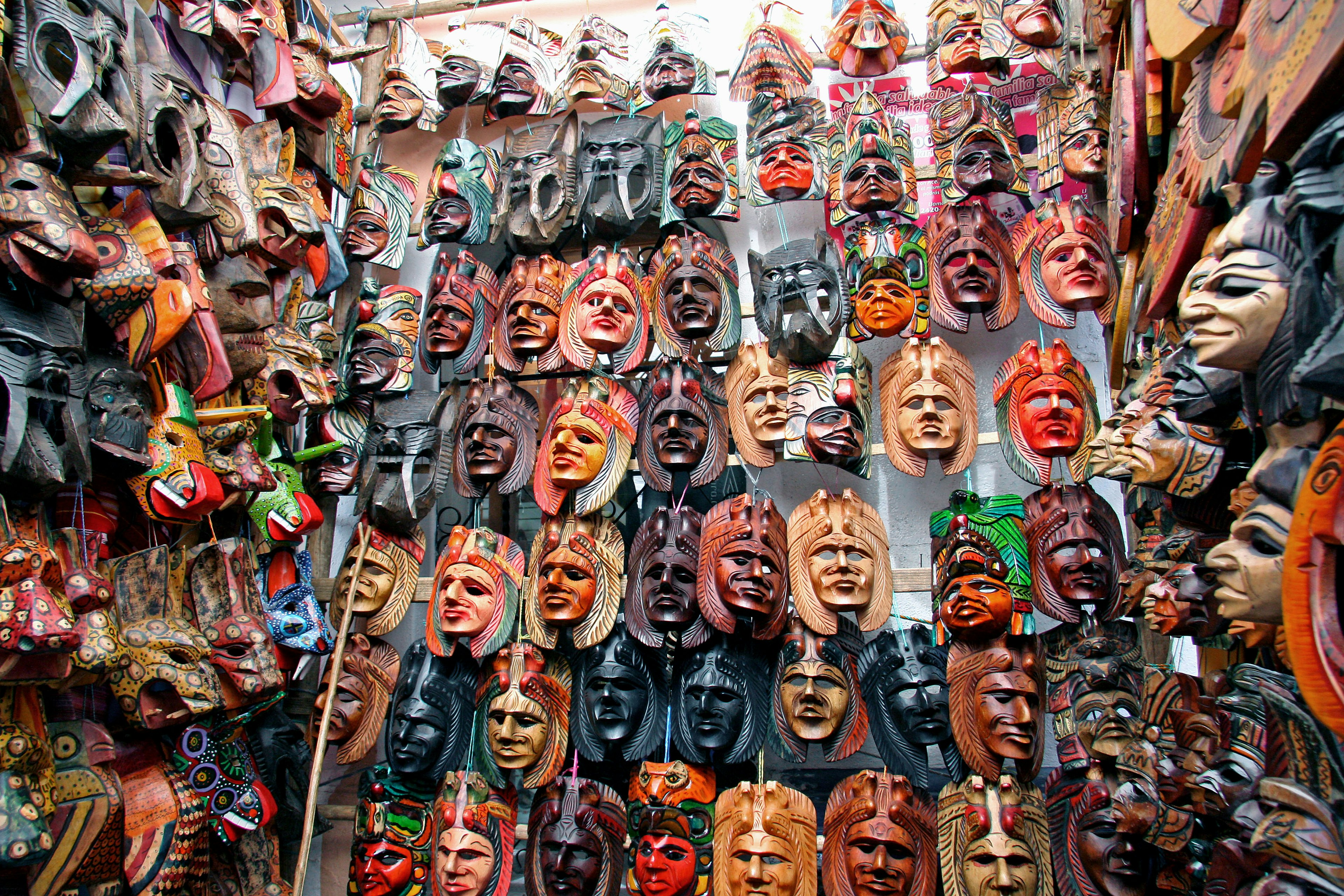 A vibrant display of various masks hanging on a wall