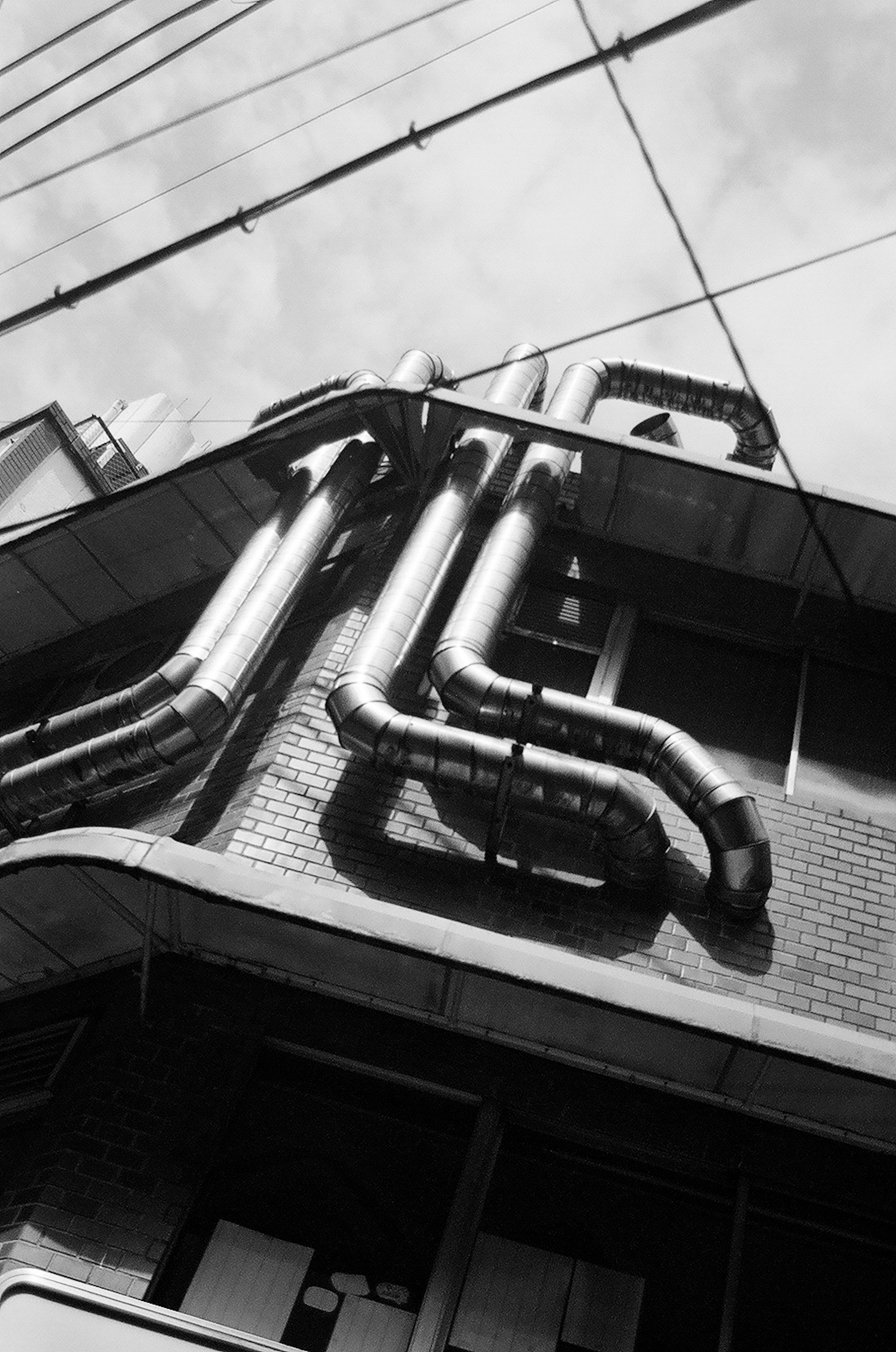 Complex arrangement of metal pipes on a black and white building